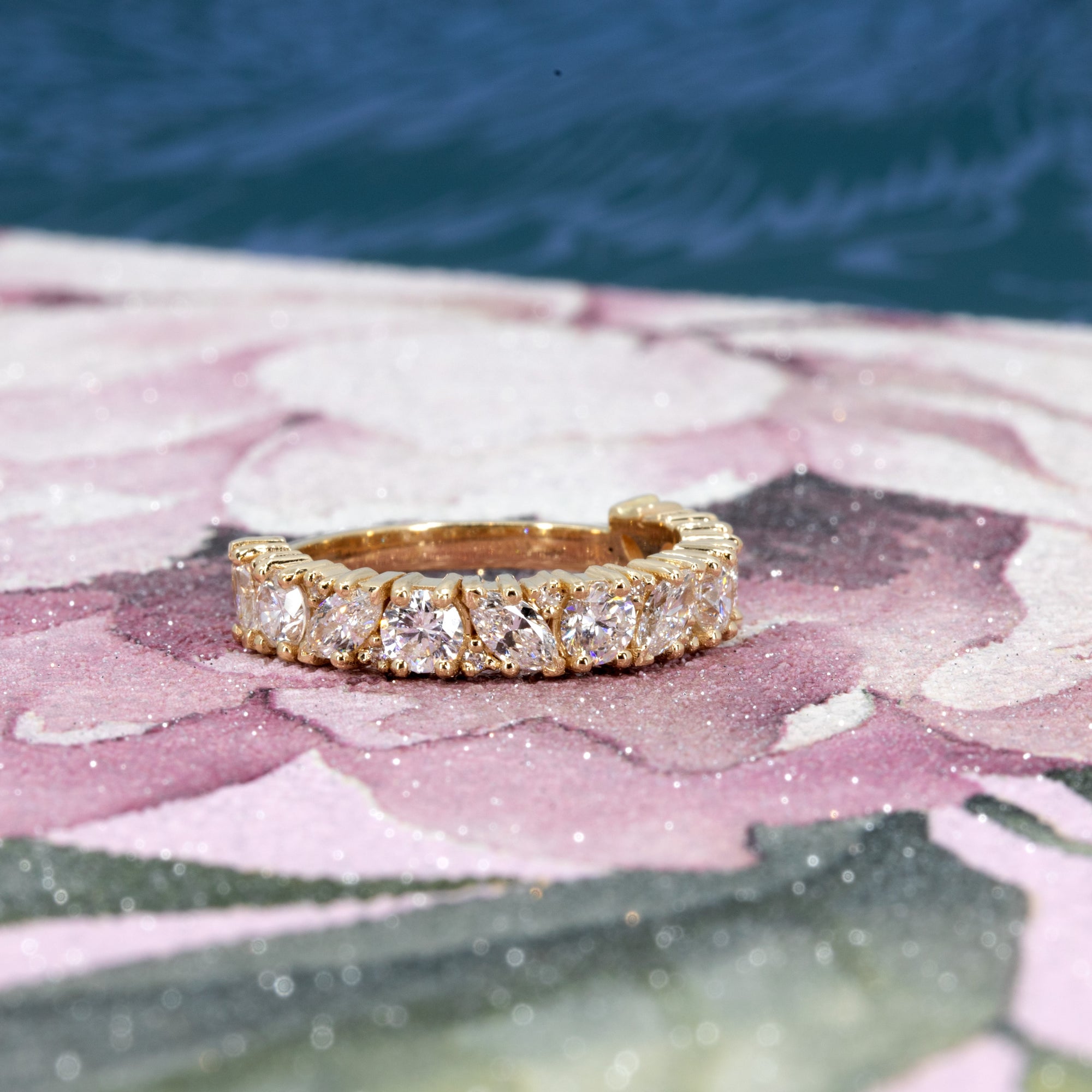 14 kt yellow gold wedding band with marquise and round lab-grown diamonds worn on the hand, showcasing its bold elegance crafted by  Bena Jewelry designer.