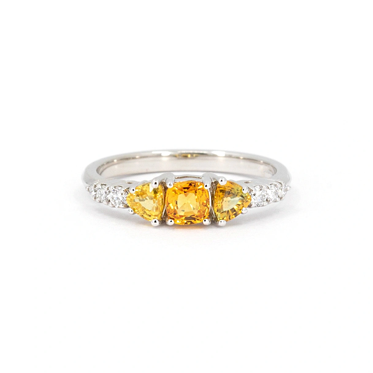 Orange sapphire and diamond engagement ring, seen on a white background. Fine jewelry piece designed by Bena Jewelry, in Montreal, Canada.