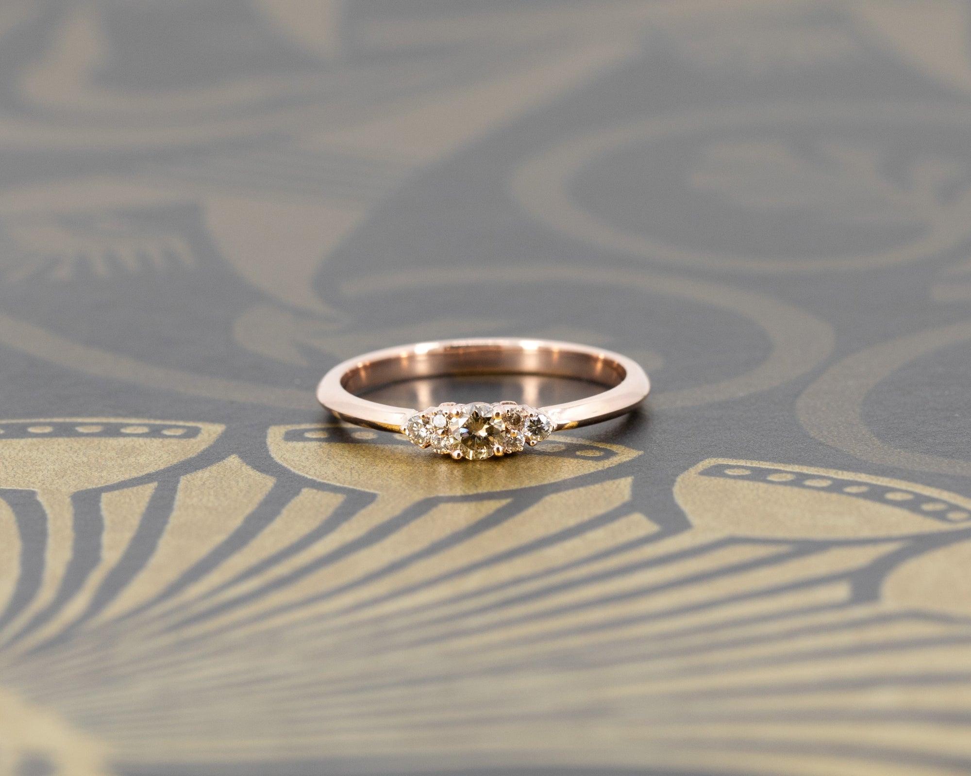 Champagne diamond engagement ring by Bena Jewelry, set on a rose gold band. Displayed on a dramatic dark background, emphasizing its modern yet timeless elegance. Handmade in Montreal, Canada.