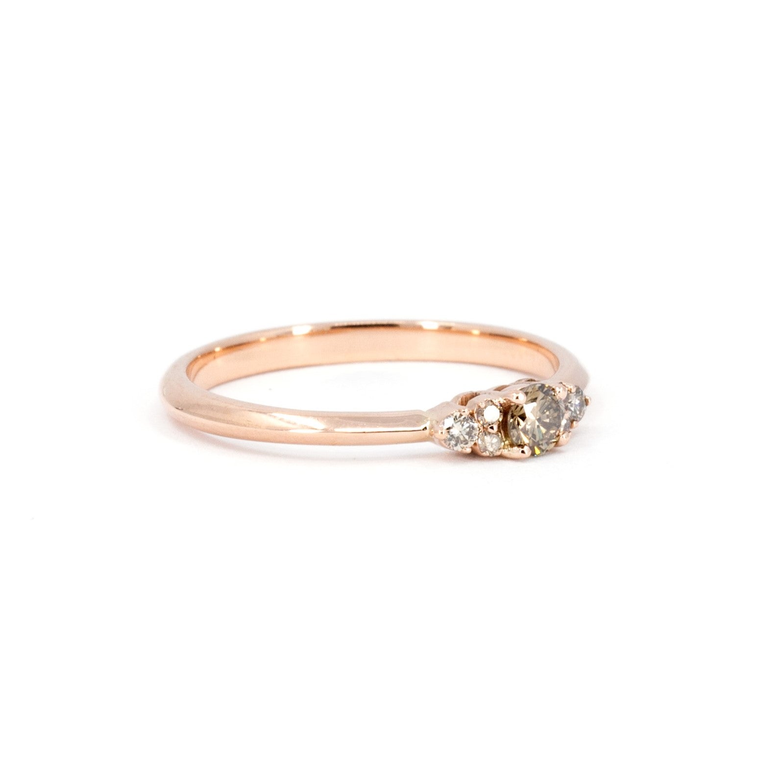 Champagne diamond engagement ring with golden hues by Bena Jewelry. This classic design includes sparkling side diamonds and a rose gold band. Photographed on a white background to highlight its elegance, made in Montreal.