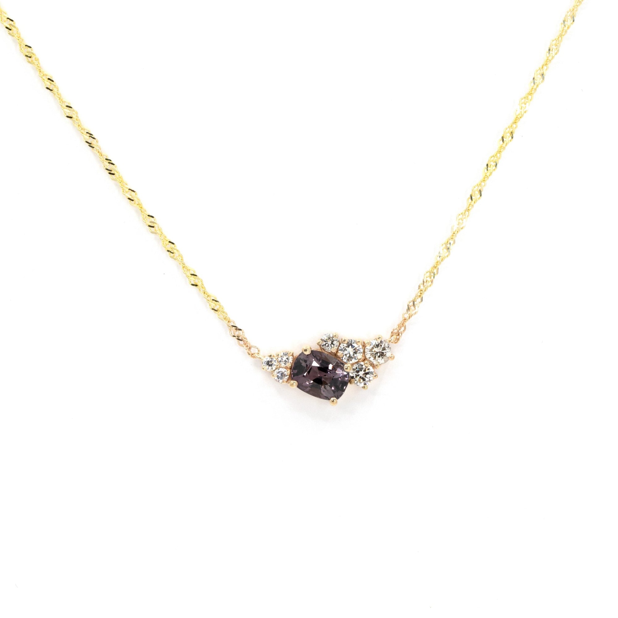 Asymmetrical Spinel & Diamond Pendant on a white background – A unique fine jewelry piece with an electric gray spinel and scattered round diamonds.