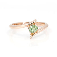 oval shape demantoid garnet ring custom made in montreal by bena jewelry on white background