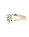 side view of rose gold green demantoid garnet ring custom made by bena jewelry on white background