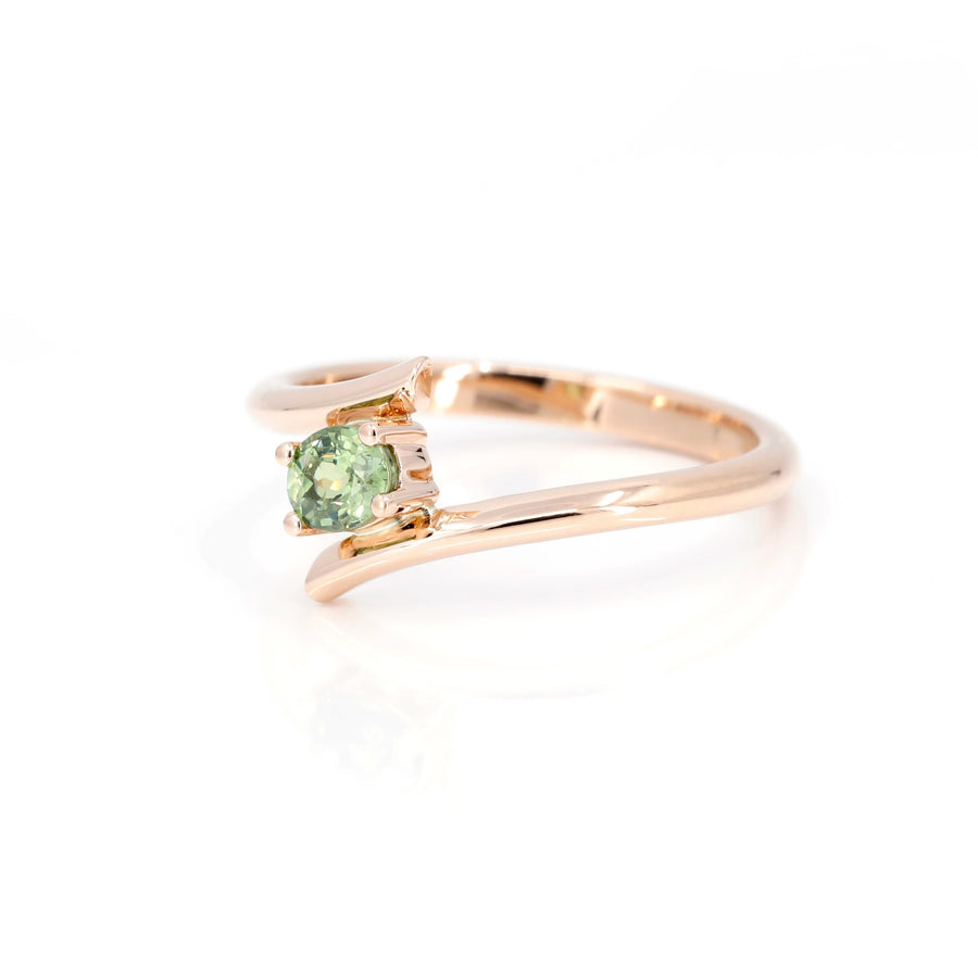 side view of rose gold green demantoid garnet ring custom made by bena jewelry on white background