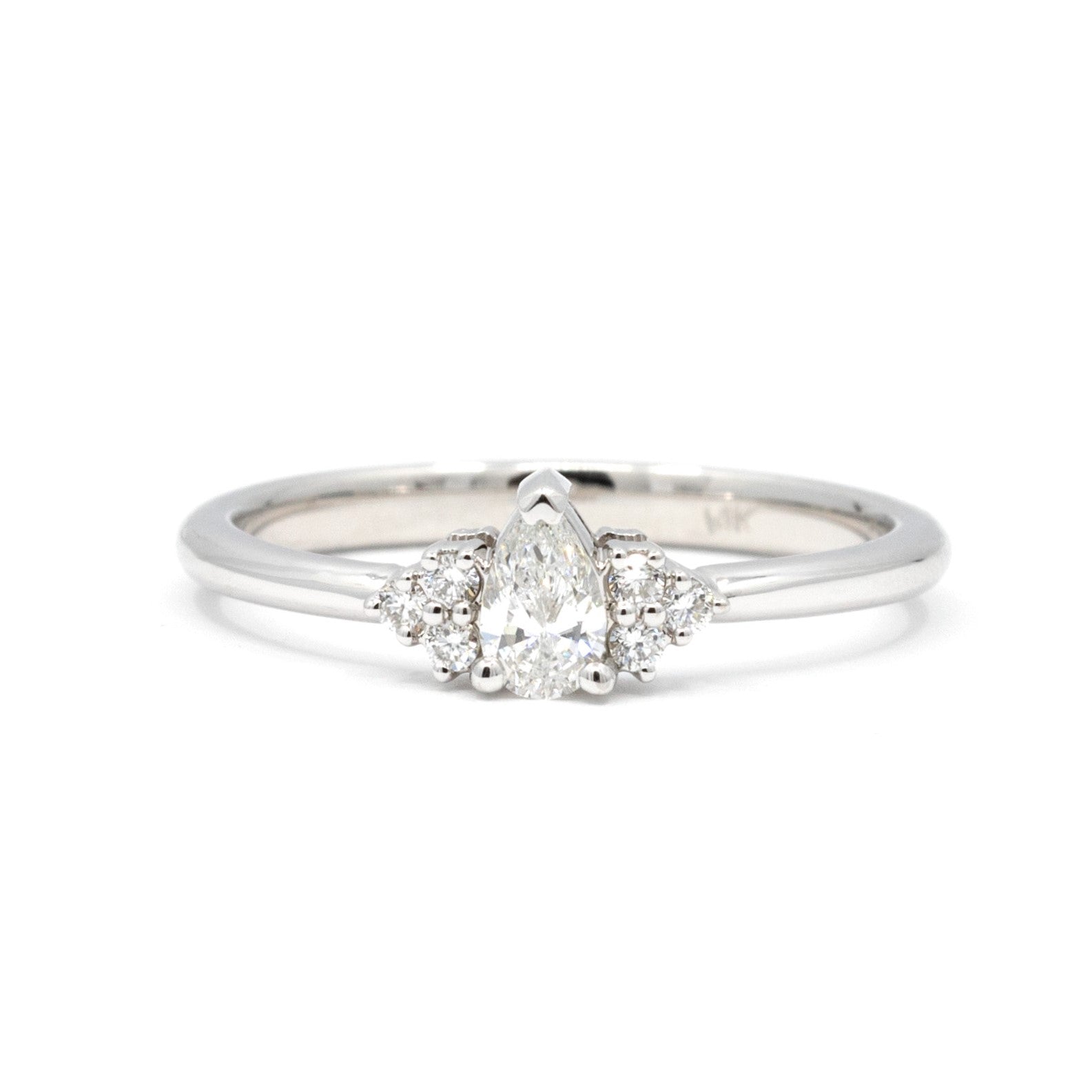Désir Ring with a pear-shaped diamond and side diamonds, set in white gold. Handmade by Bena Jewelry in Montreal.