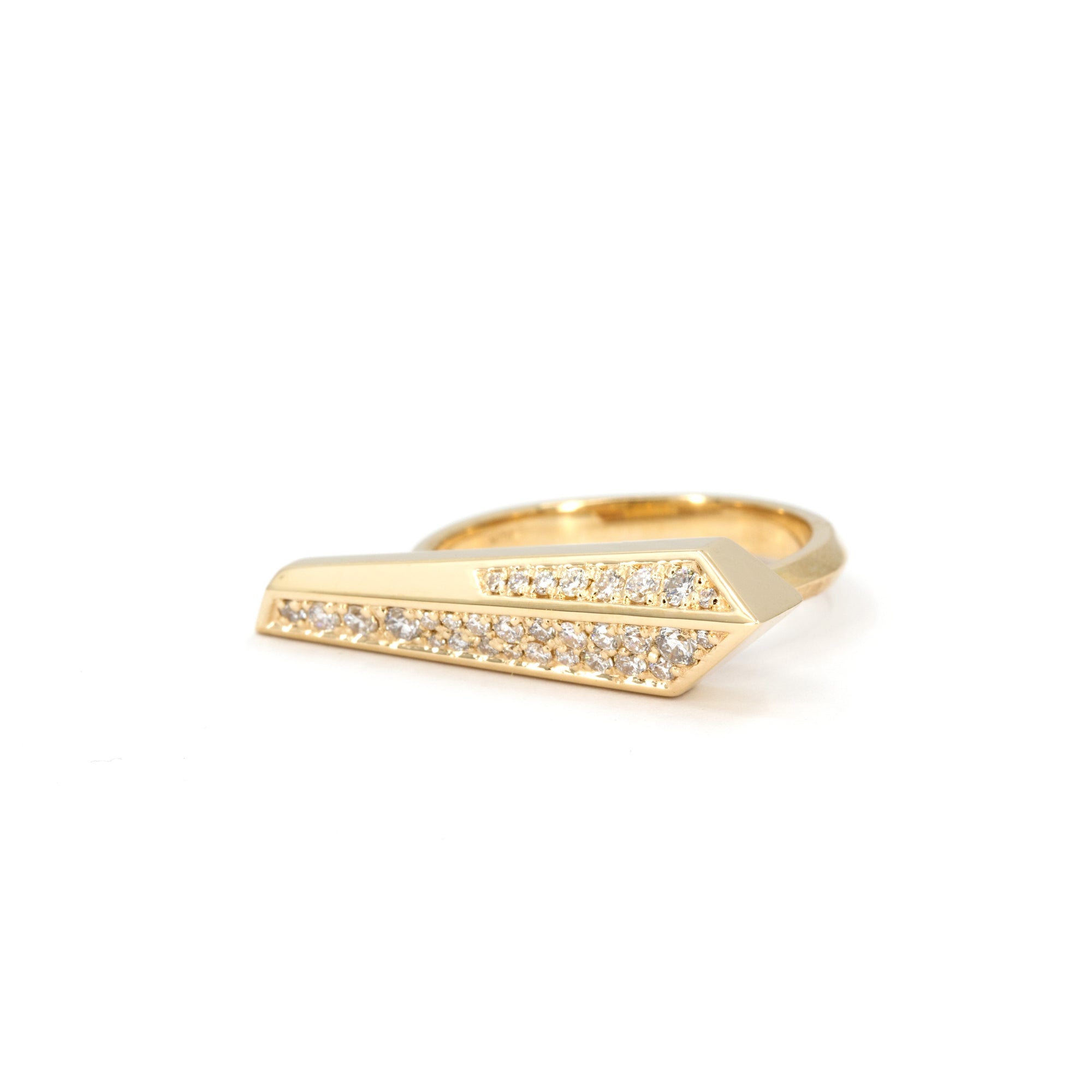 Architectural diamond ring in yellow gold by Bena Jewelry, showcasing sharp geometric lines and brilliant pavé diamonds on a clean white surface.