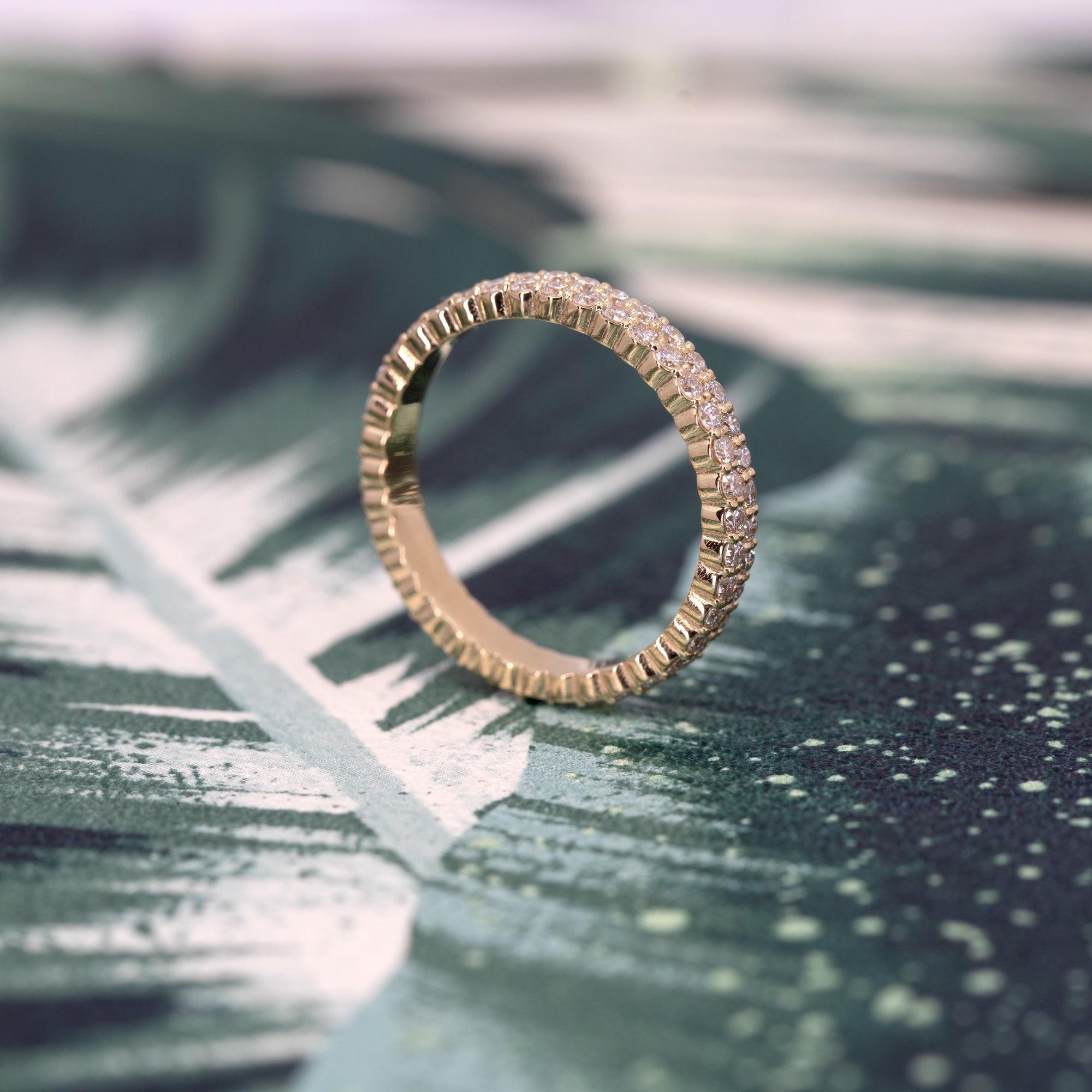 Modern and bold 14K yellow gold wedding band with two rows of dazzling diamonds, styled by Bena Jewelry. Handmade in Montreal, Quebec, this luxurious piece is perfect for women who value timeless fine jewelry made in Canada.