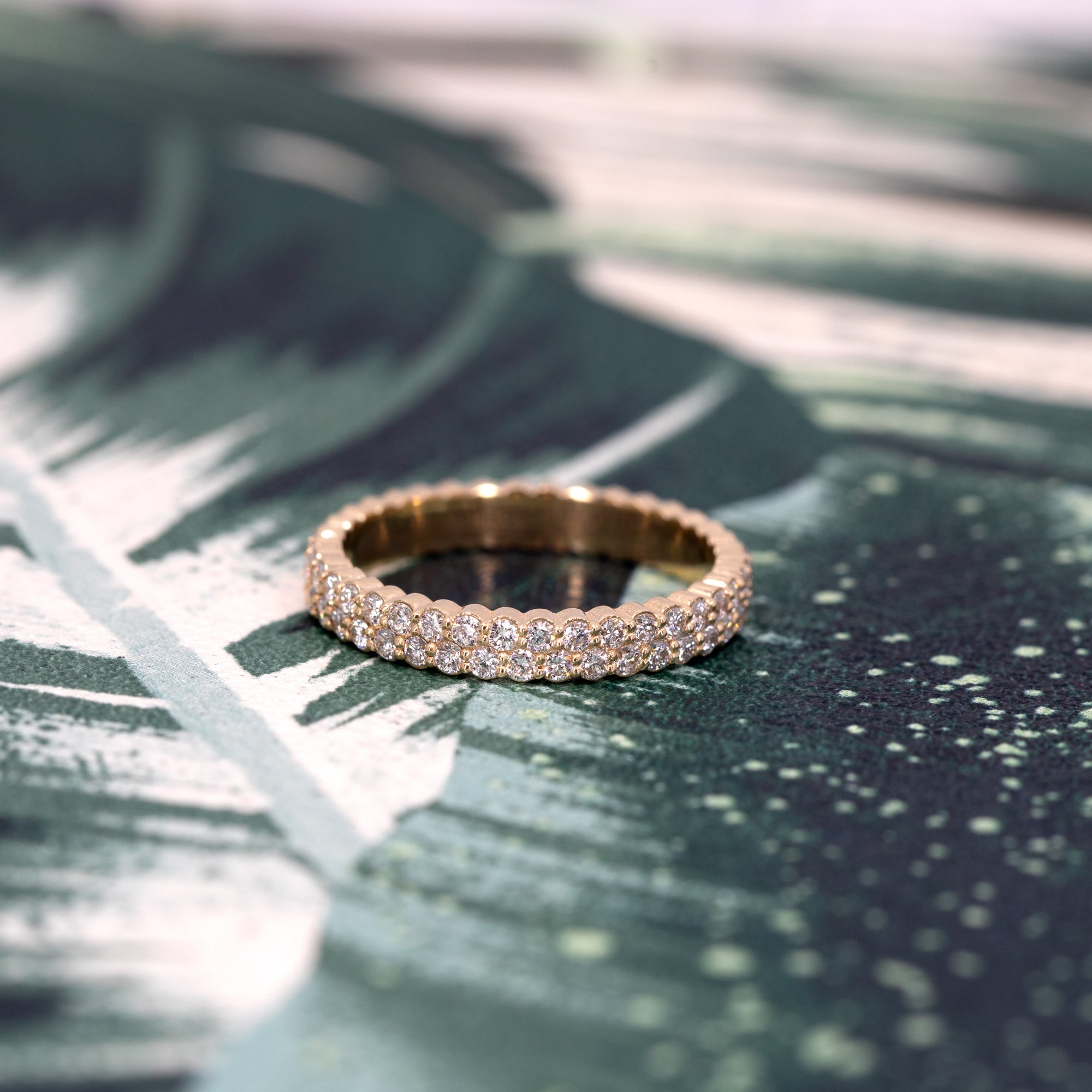 A classic wedding band in 14K yellow gold with two rows of 1.50 mm diamonds. This elegant design showcases the brilliance and timeless sophistication of Bena Jewelry&#39;s craftsmanship.