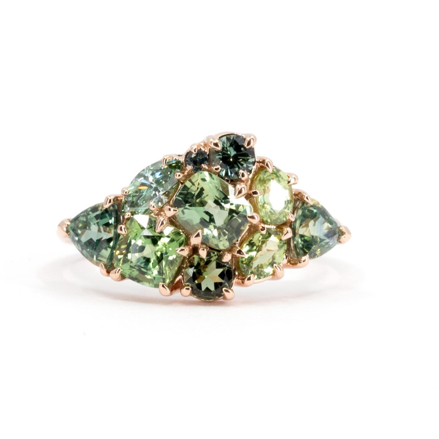 Front view: The Avalanche Marvy Moss Ring showcasing its artistic arrangement of teal sapphires and dark green gemstones in a polished rose gold setting. Designed by Bena Jewelry in Montreal, Canada.