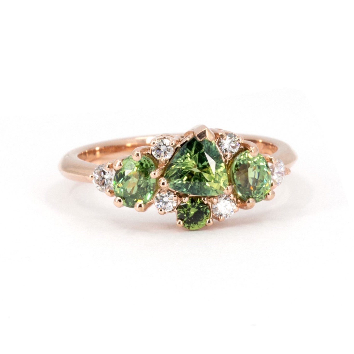 Unique designer ring featuring green sapphire and demantoid garnet gemstones, set in rose gold. Made by Bena Jewelry in Montreal, Canada.