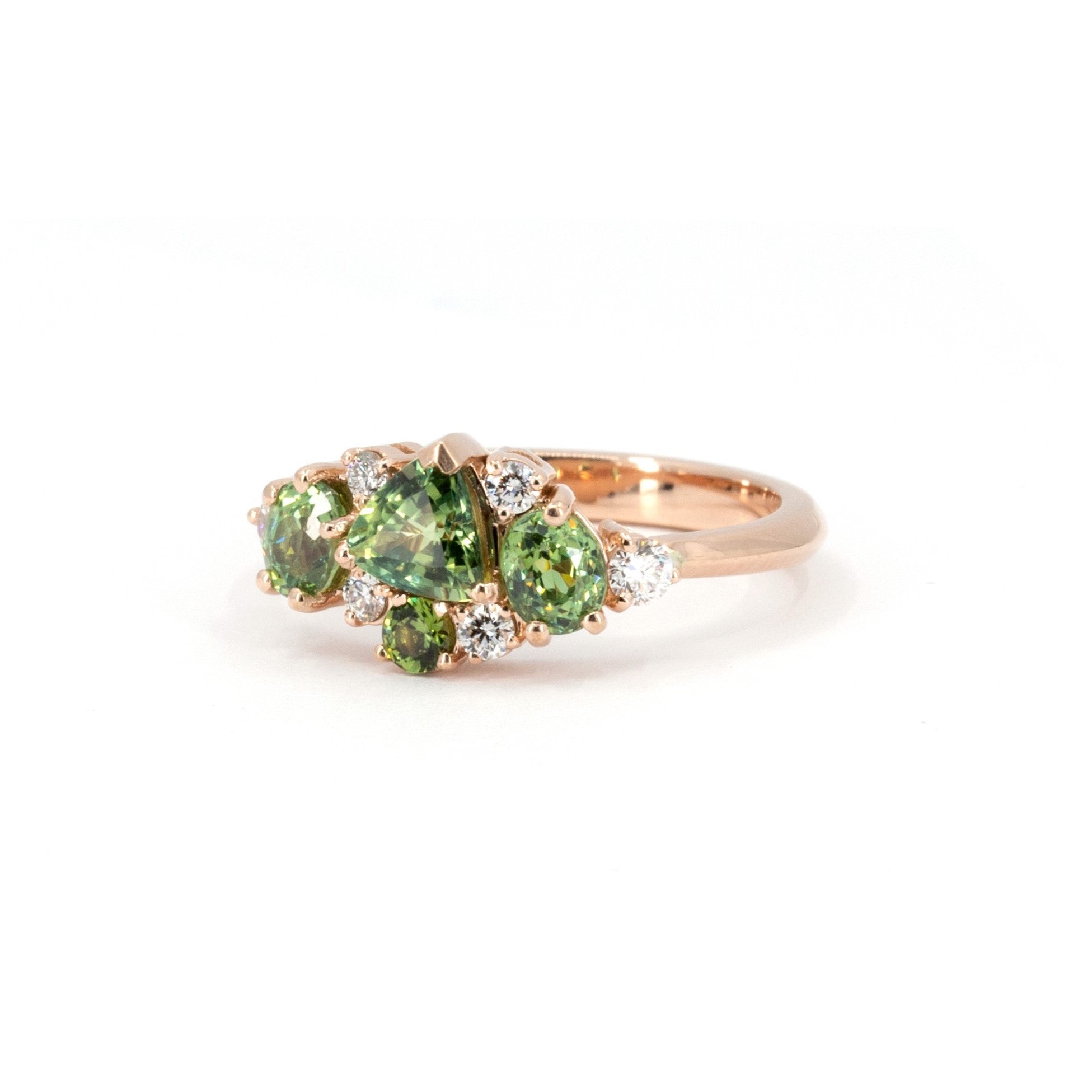 Rose gold ring with vibrant green sapphire and deep green garnets, a custom creation by Bena Jewelry in Montreal.
