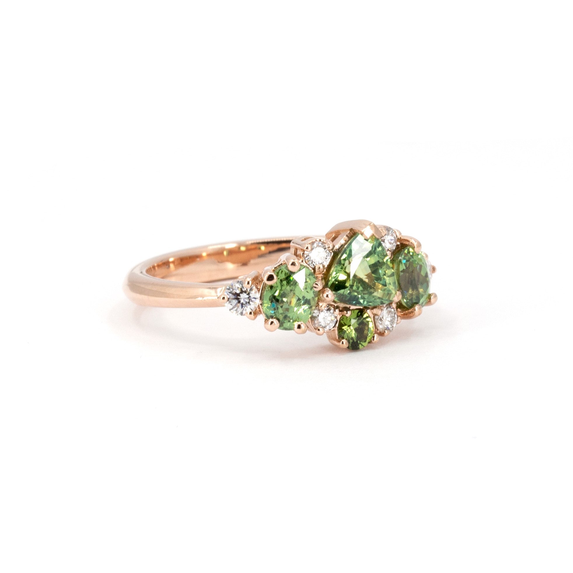 One-of-a-kind ring with green sapphire and demantoid garnets, crafted in rose gold by Canadian designer Bena Jewelry in Montreal.