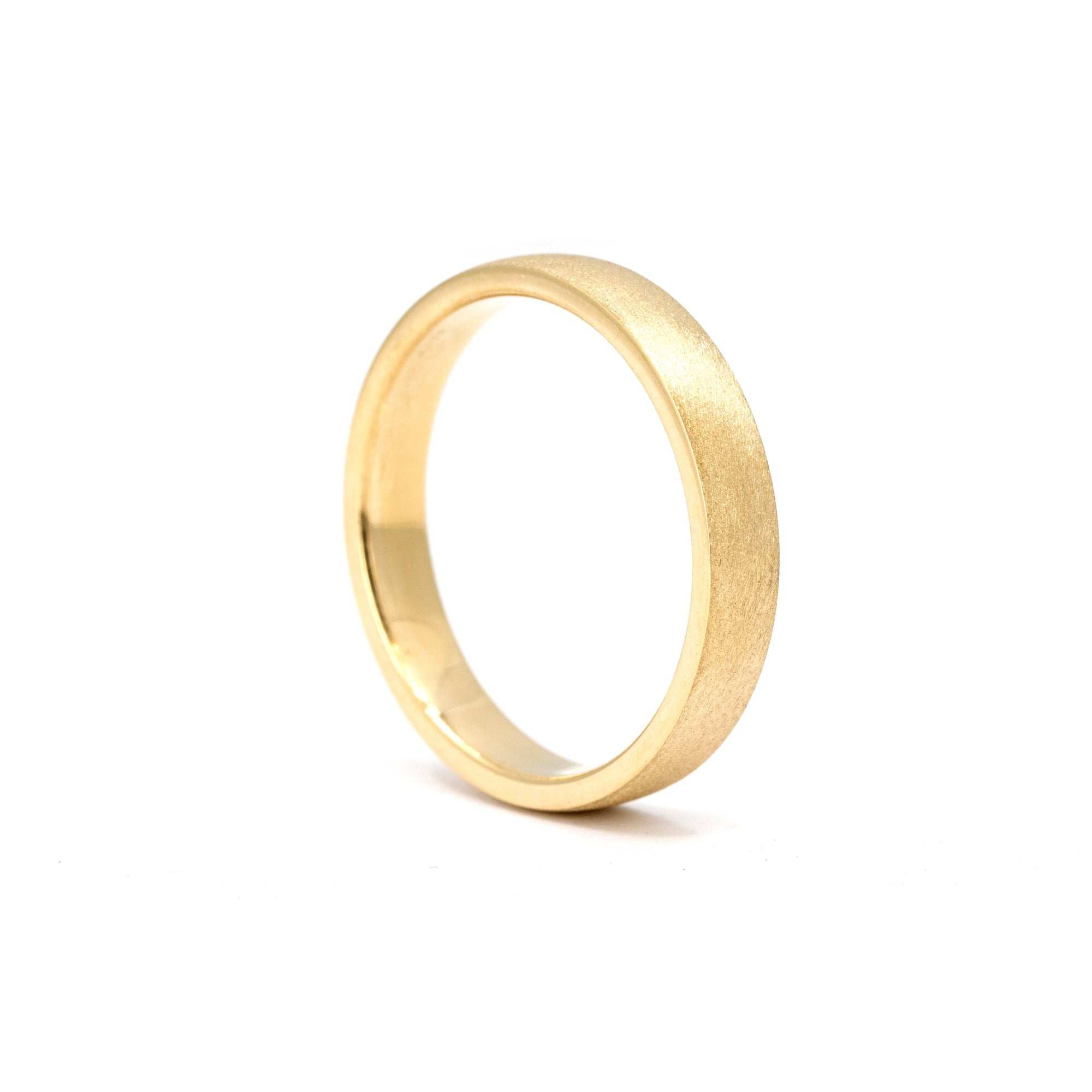Matte gold men’s wedding band in yellow gold, handcrafted by Bena Jewelry in Montreal.