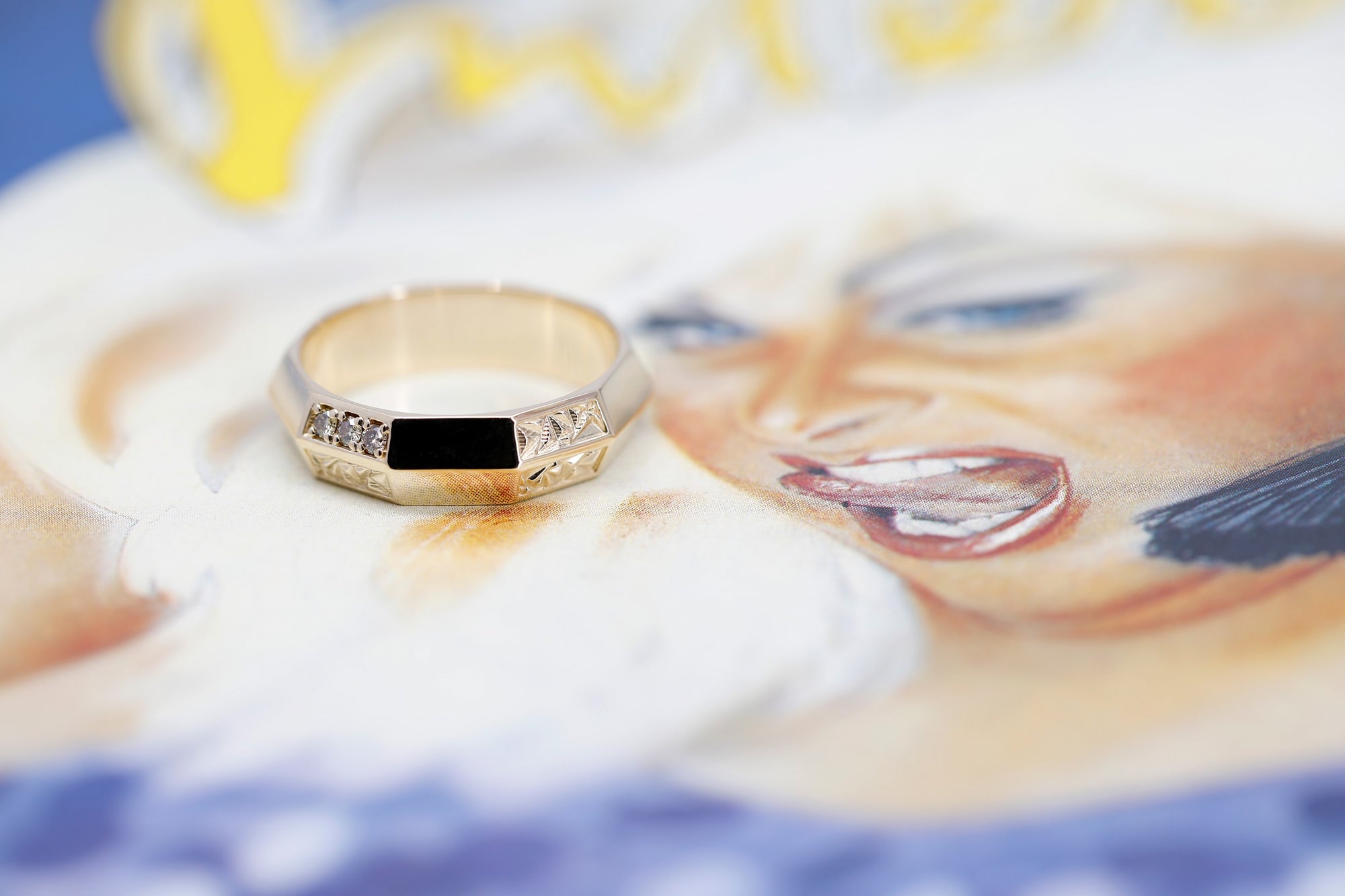 designer men wedding band yellow gold brown diamond ring on multi color background