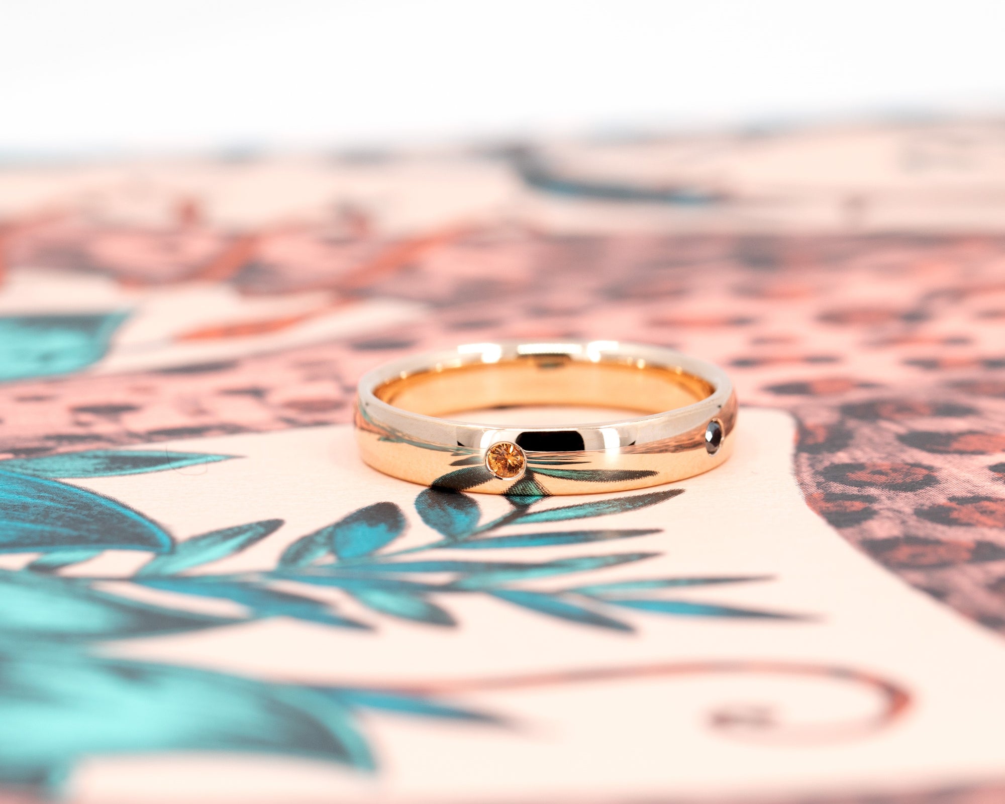 Multi Colored Gemstone Band in rose gold featuring bezel-set vibrant gemstones by Bena Jewelry photographed on a dark background custom men&#39;s jewelry made in Montreal