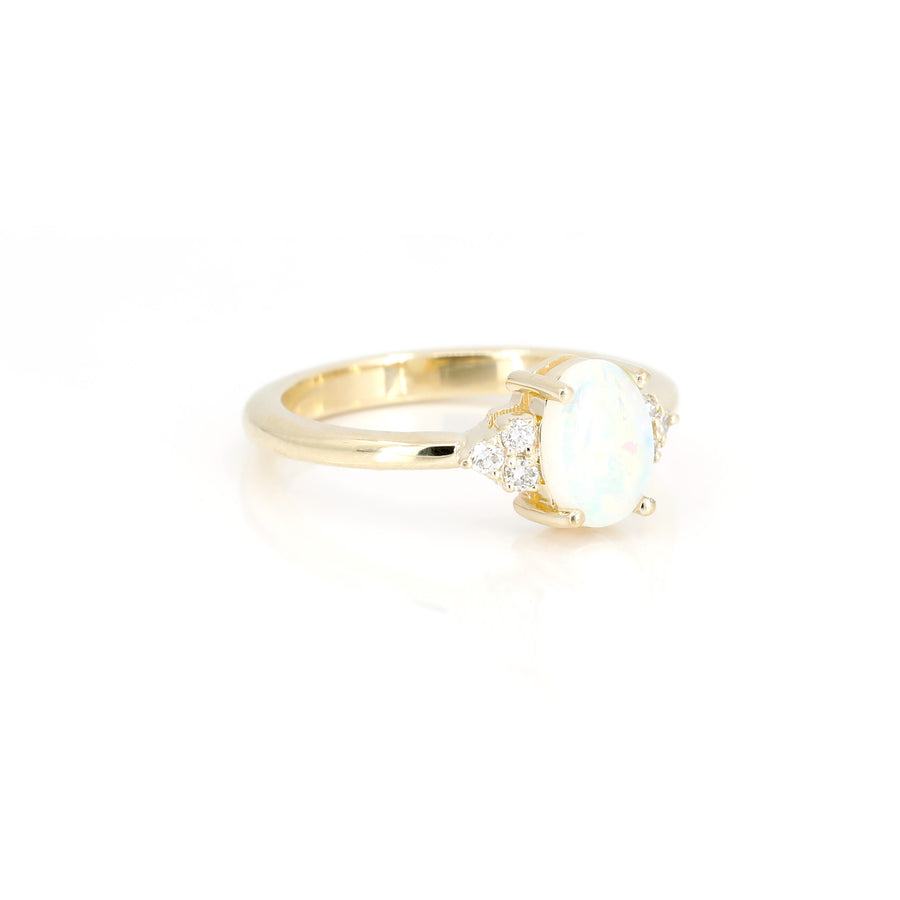 side view of diamond and opal engagement ring custom made in montreal by bena jewelry on white background
