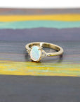 opal and diamond bridal engagement by bena jewelry designer ring custom made in montreal in yellow gold on multi color backgroud