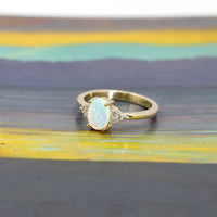 opal and diamond bridal engagement by bena jewelry designer ring custom made in montreal in yellow gold on multi color backgroud