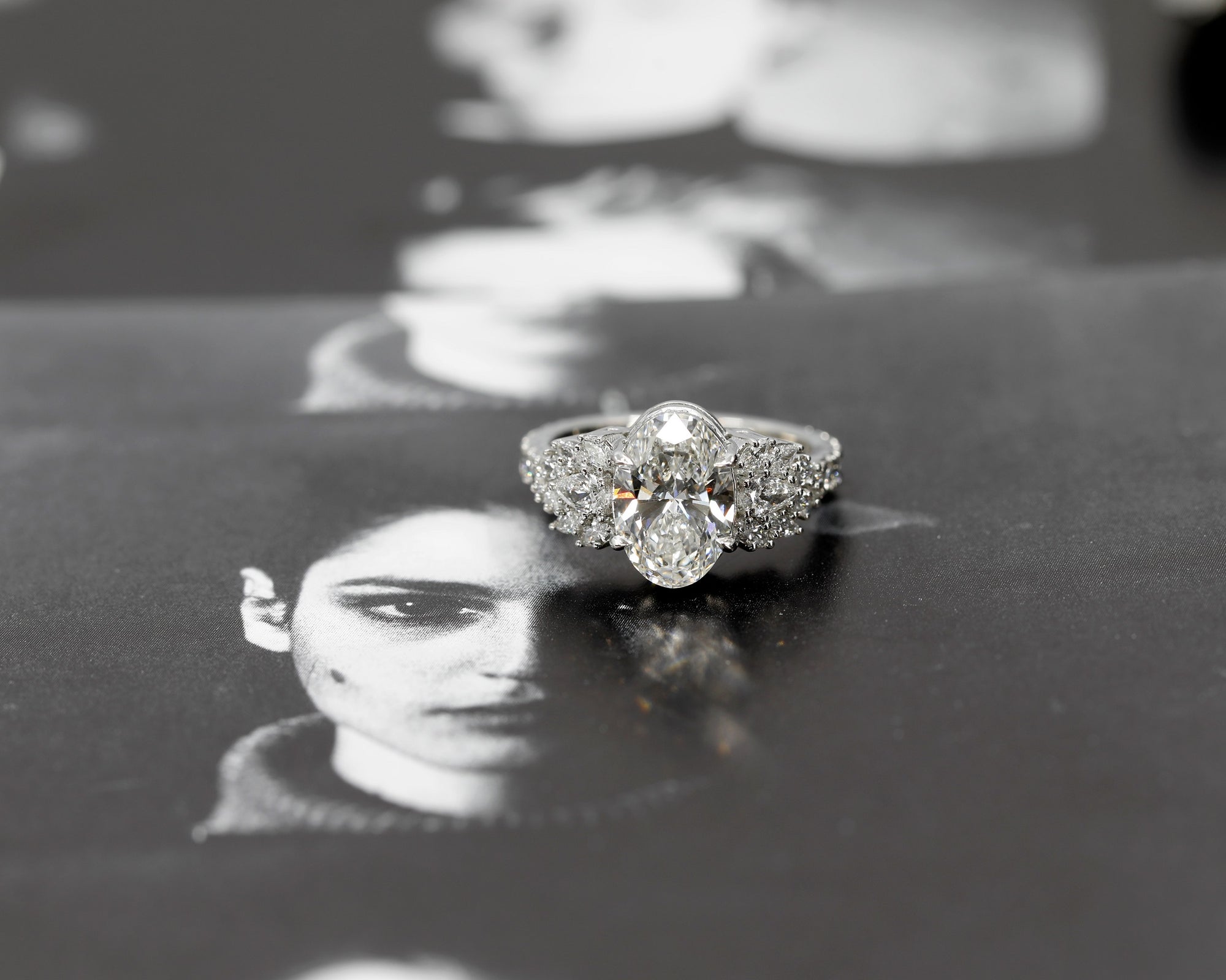 front view of oval shape lab grown diamond and maquise shape pear side gemstone made in montreal by bena jewelry in collaboration with boutique ruby mardi finest jeweler in canada on back background