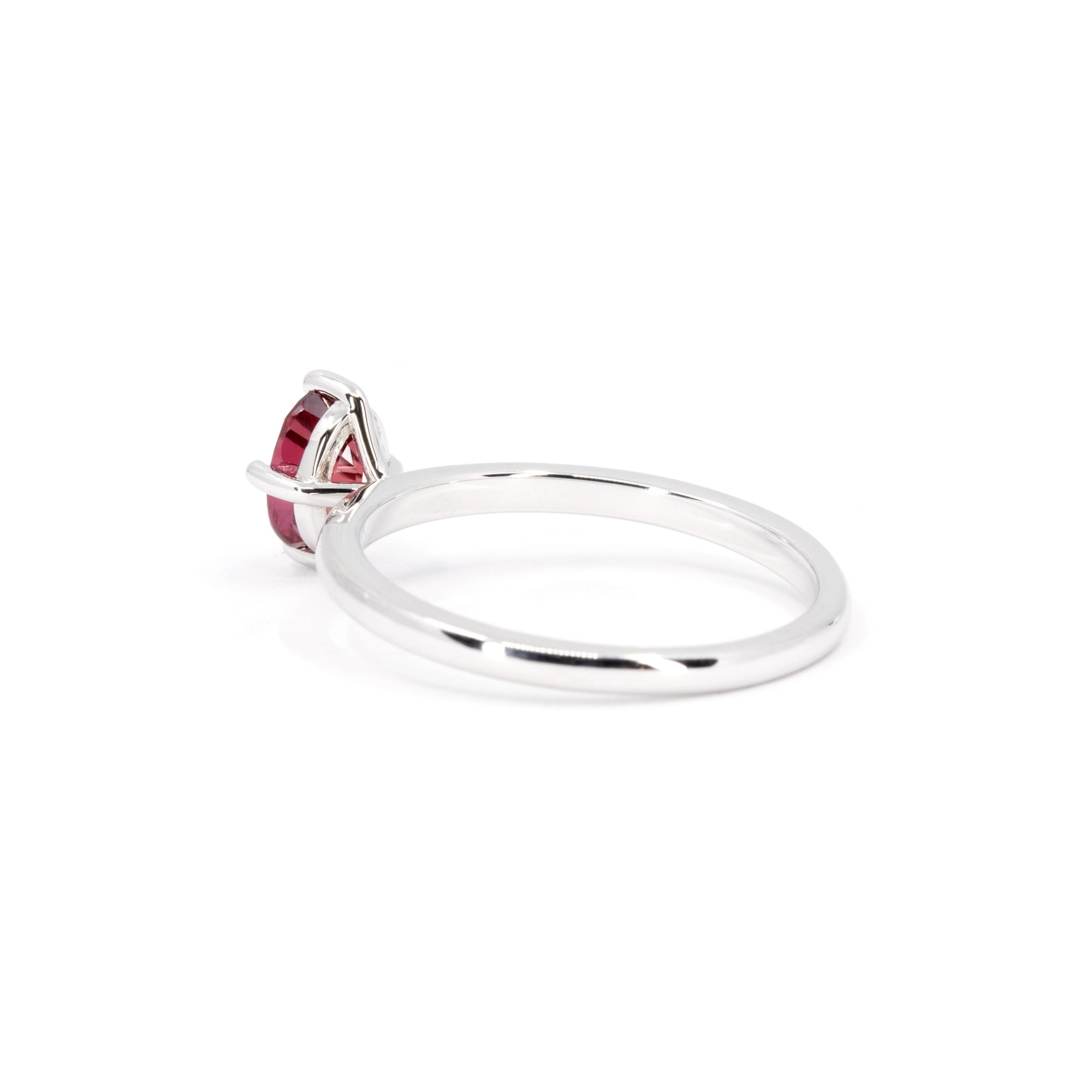 Back view of minimalist white gold ring featuring a vibrant oval ruby, designed by Canadian jewelry designer Bena Jewelry.