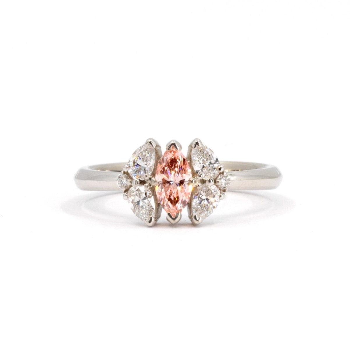 Custom Salmon Pink Marquise Diamond Engagement Ring, made in Montreal – A bespoke bridal ring featuring a central marquise-cut pink diamond surrounded by pear-cut diamonds, handcrafted by Bena Jewelry.