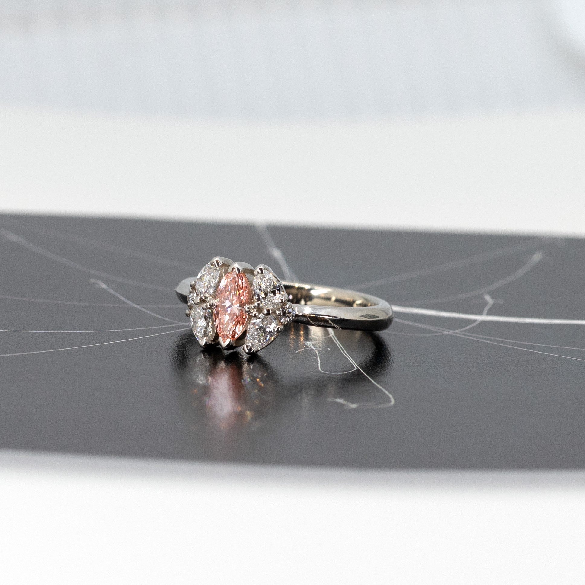 Salmon Pink Marquise Diamond Ring worn on the hand, a custom bridal piece by Bena Jewelry – A refined engagement ring, handcrafted in Montreal, perfect for those seeking a unique, timeless design.