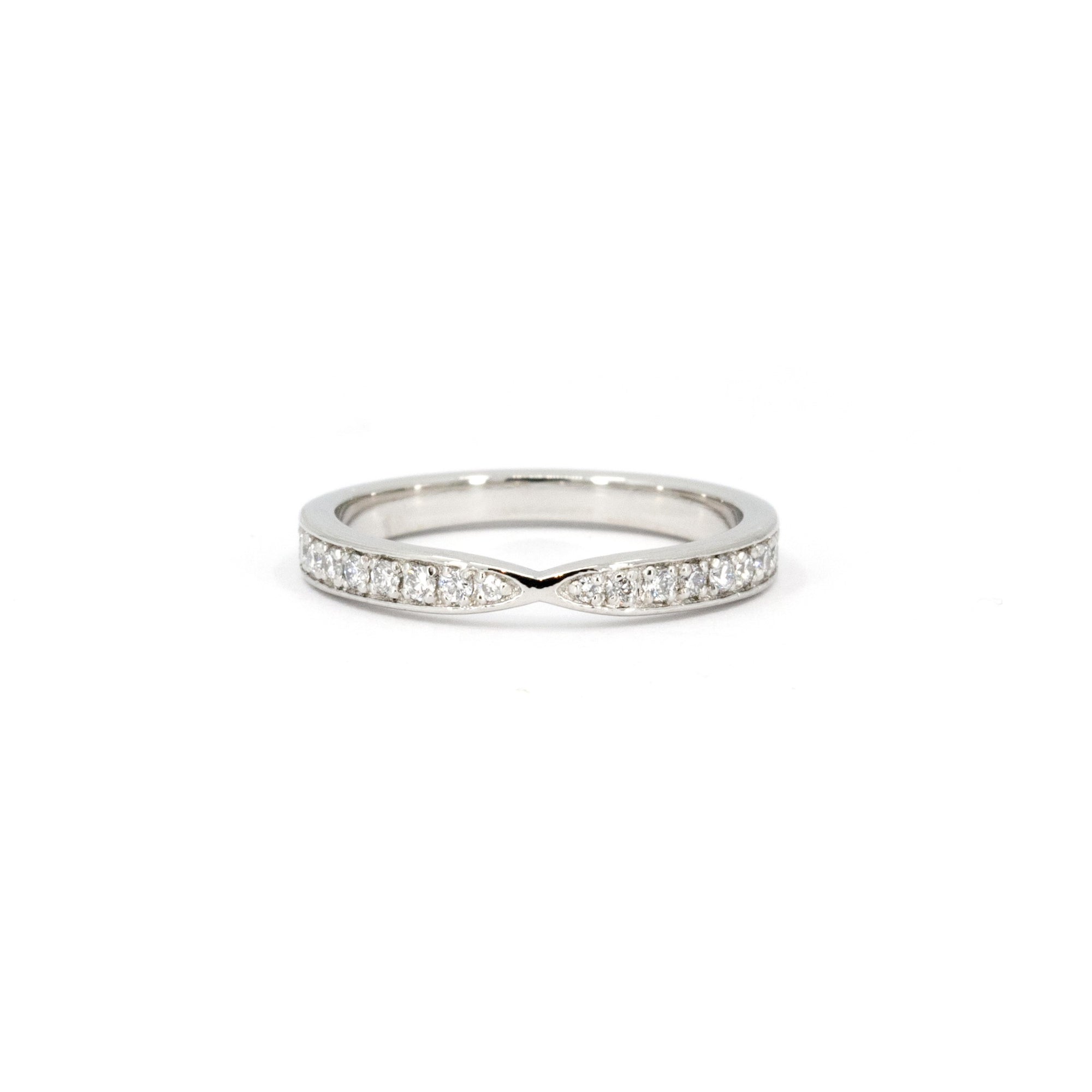 Platinum wedding band with a pinch design and diamonds, custom-made by Bena Jewelry in Montreal, Canada.