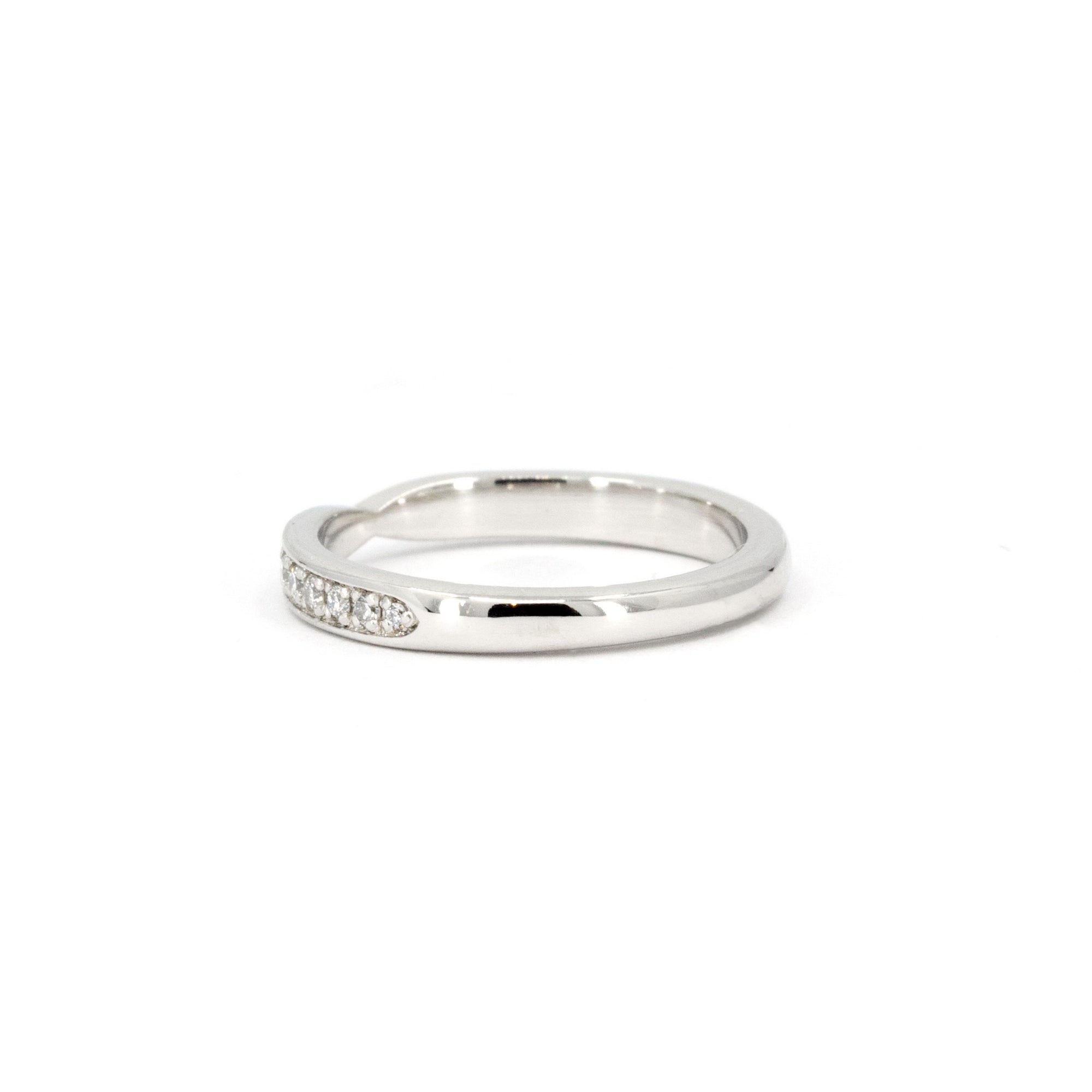 Sleek platinum wedding ring featuring a pinch detail and delicate diamonds, crafted in Montreal by Bena Jewelry, Canadian designer.