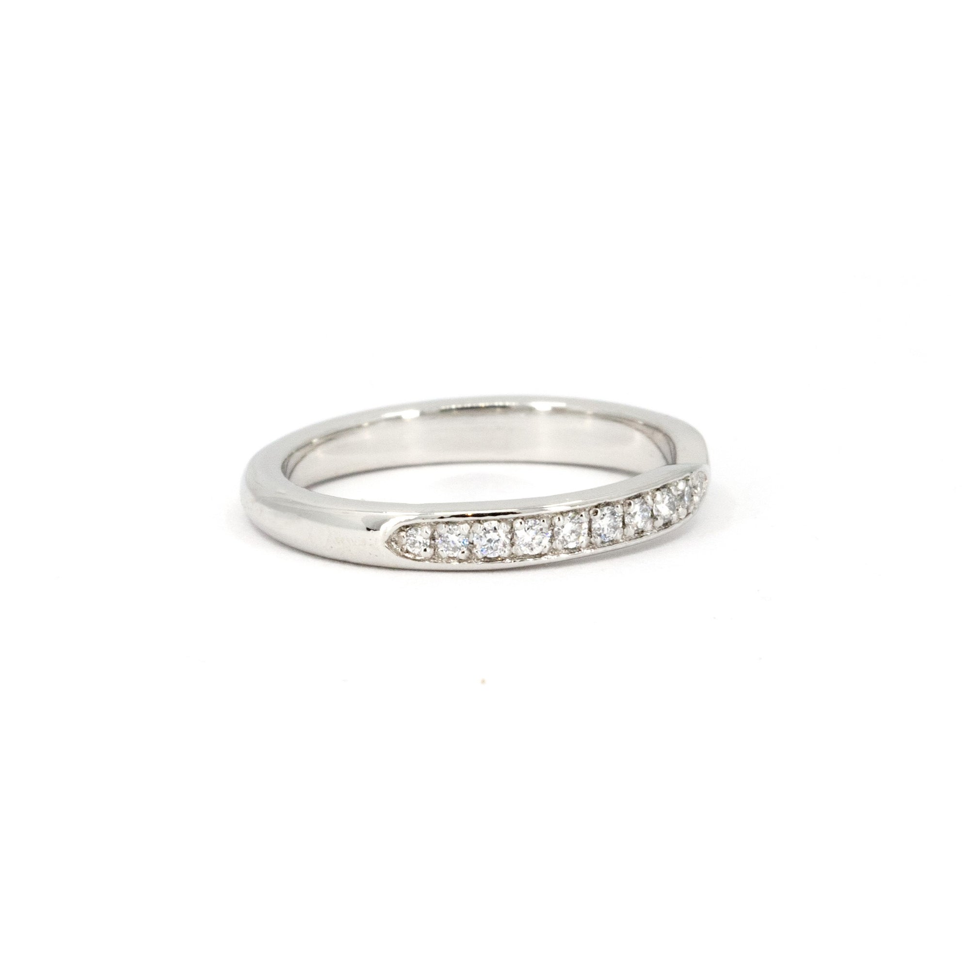 Custom bridal platinum band with pinch detail and diamonds, designed and made by Bena Jewelry in Montreal, Canada.