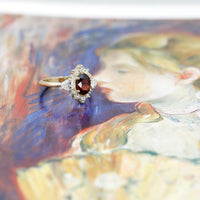 side view of bena jewelry oval shape pyrope garnet diamond ring custom made in montreal by bena jewelry