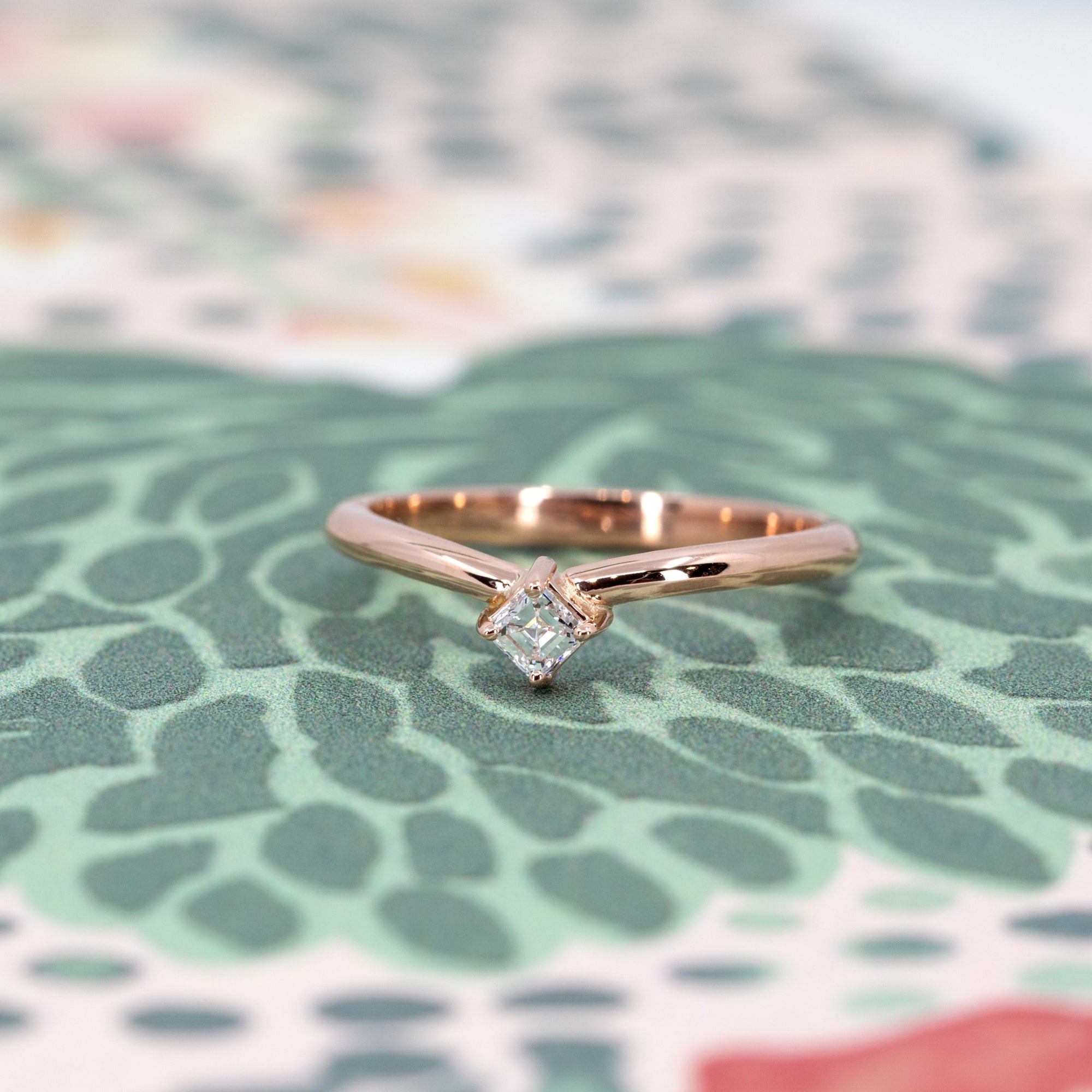 Front view of modern rose gold diamond ring, highlighting its sculptural curved band, designed by Bena Jewelry canadian designer.