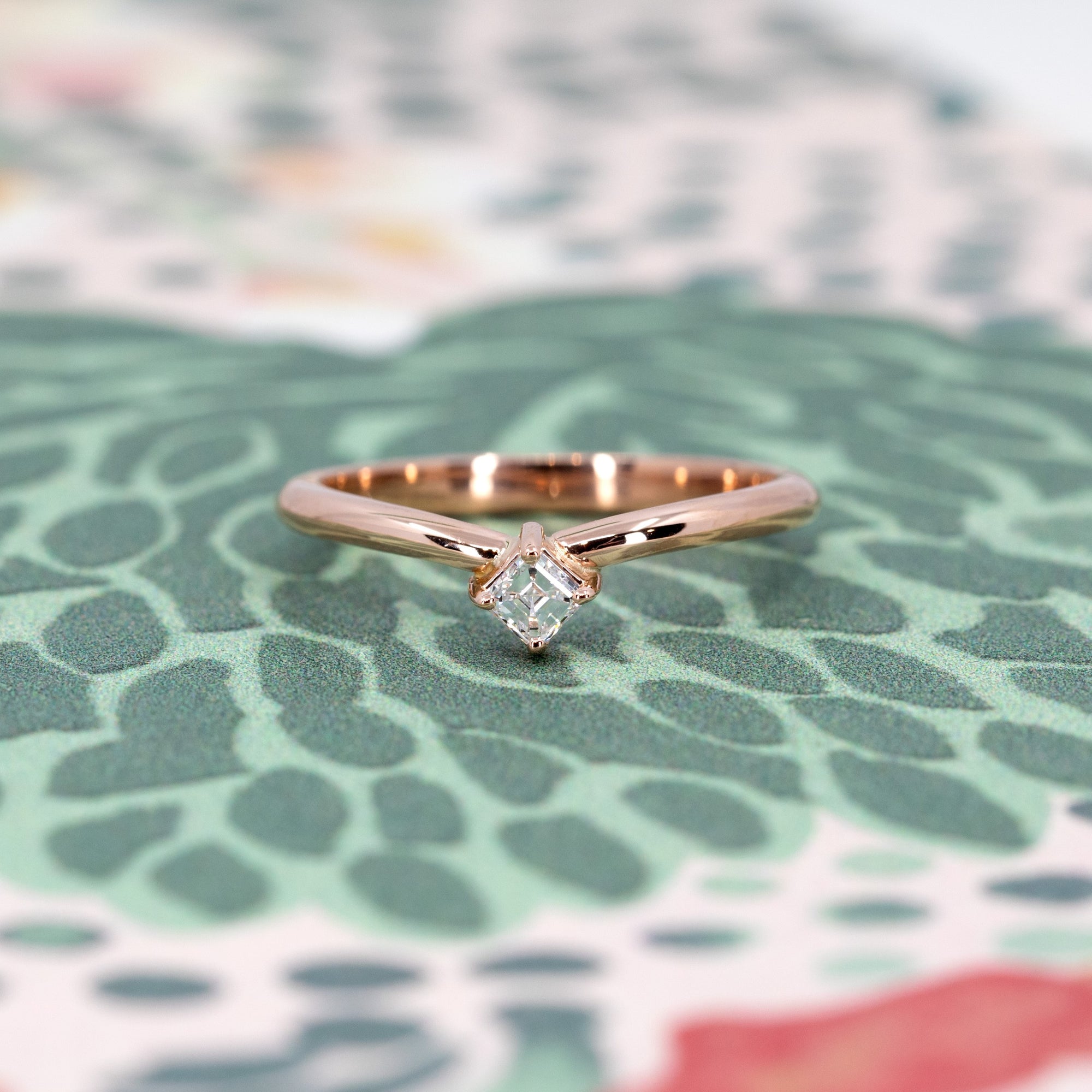 Curved rose gold ring with Asscher-cut diamond made by the indepandant designer Bena Jewelry, showcasing a bold and elegant front view.