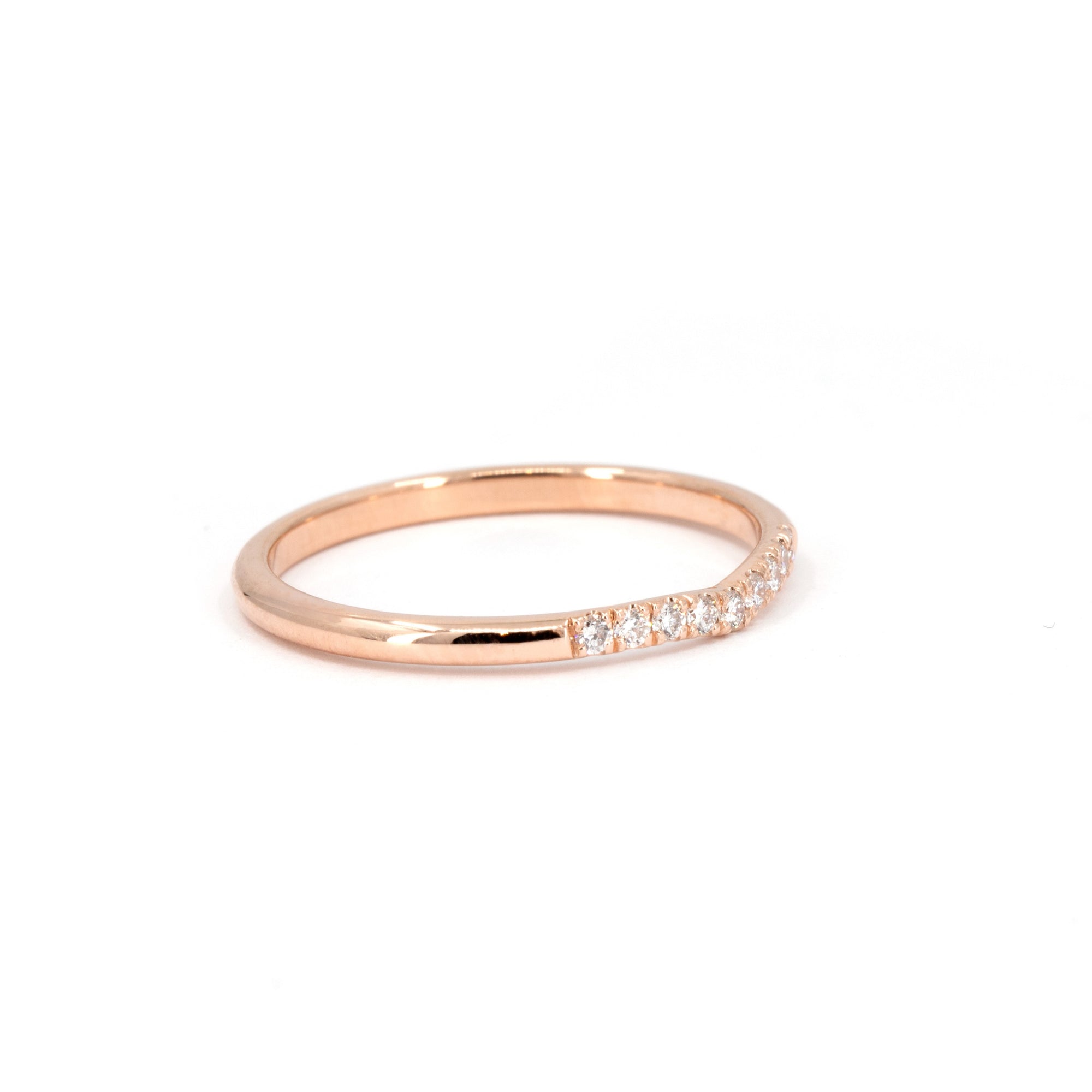 Close-up of the Luna Band, a minimalist rose gold ring with pavé diamonds, crafted by Bena Jewelry in Montreal. Perfect for stacking or as a wedding band.
