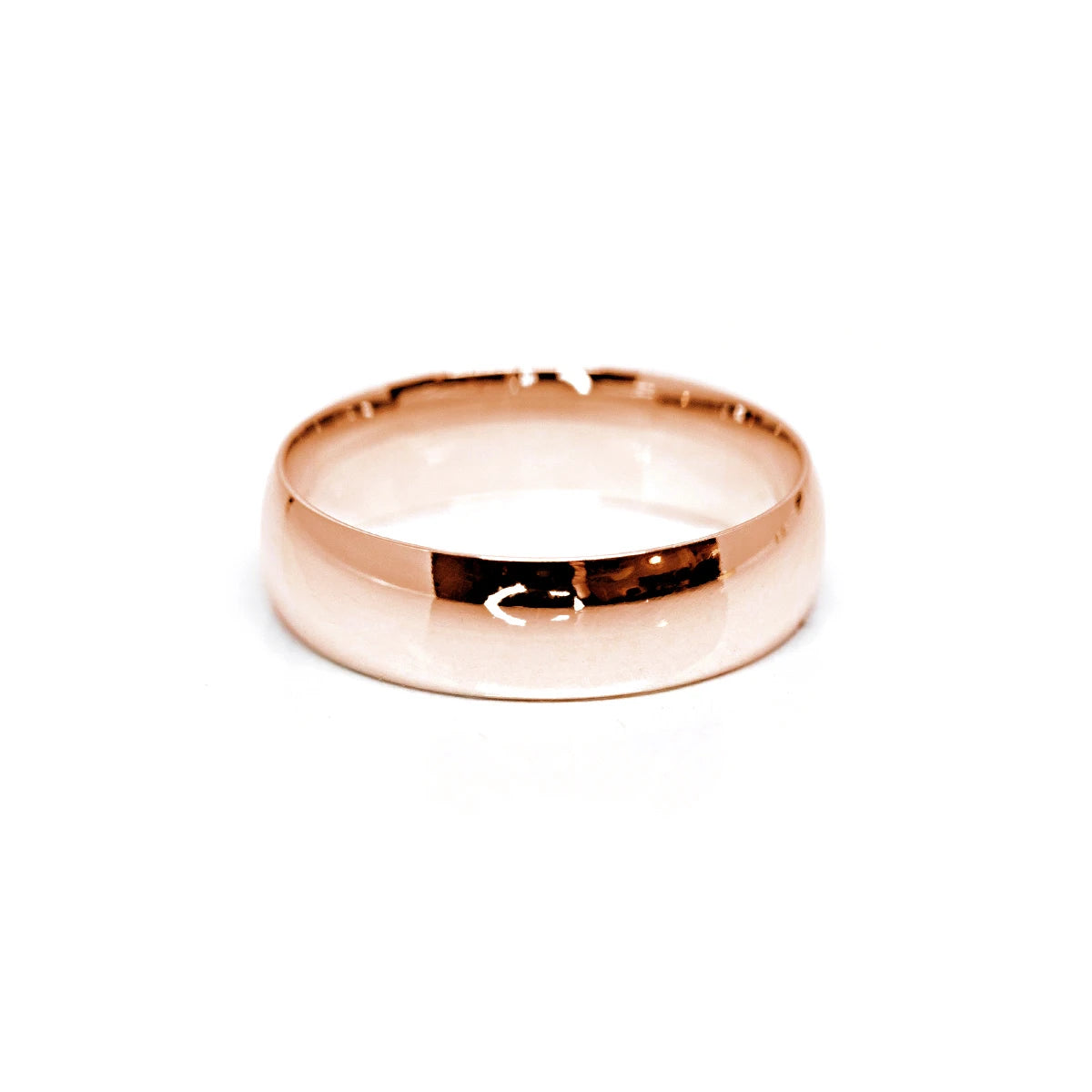 Modern rose gold domed wedding band, designed in Montreal by Bena Jewelry, featuring a high-polish finish for a sleek and contemporary wedding ring.