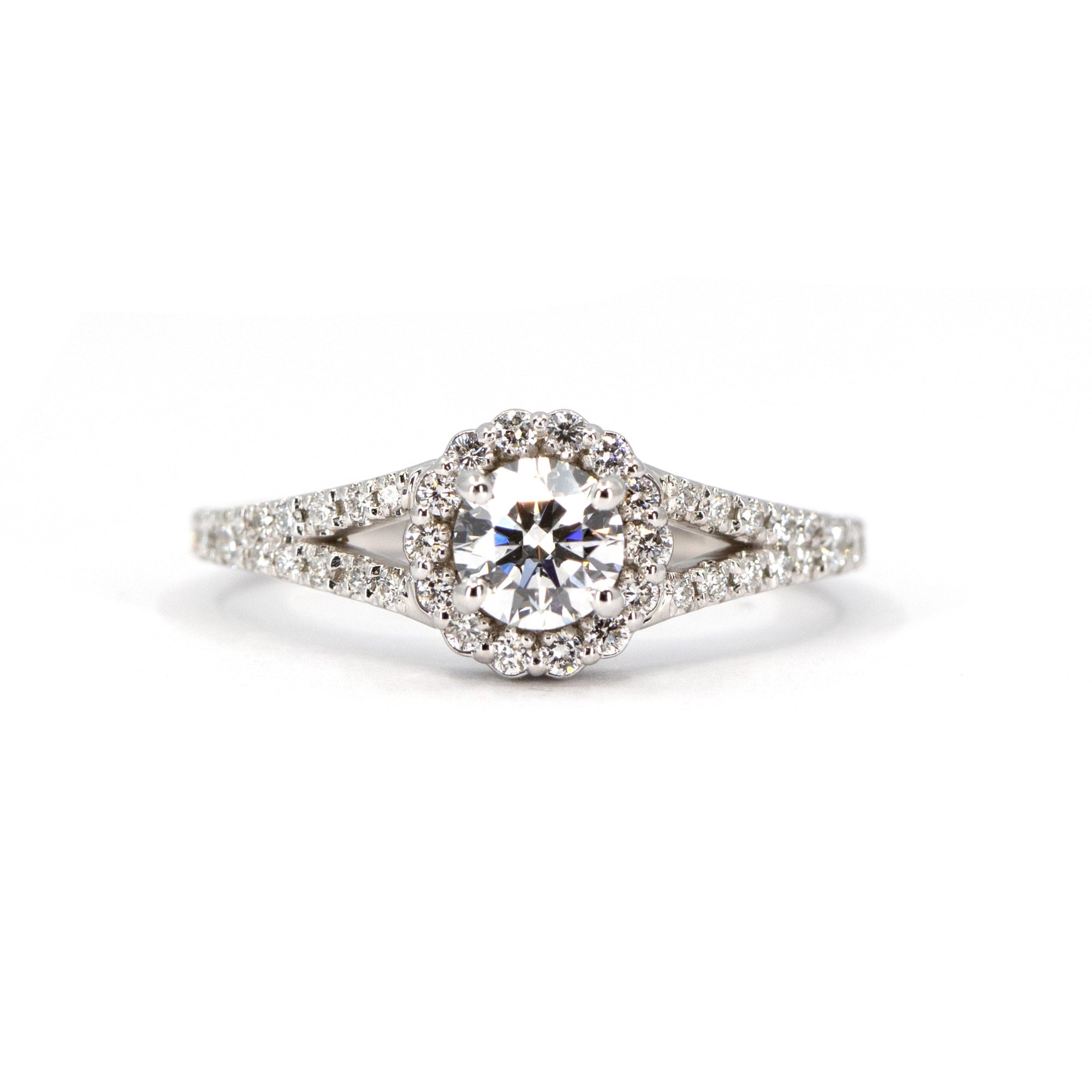 Close-up of a lab-grown diamond engagement ring in white gold. Features a round center stone, halo, and diamond accents on an open band. Custom-made by Bena Jewelry in Montreal.