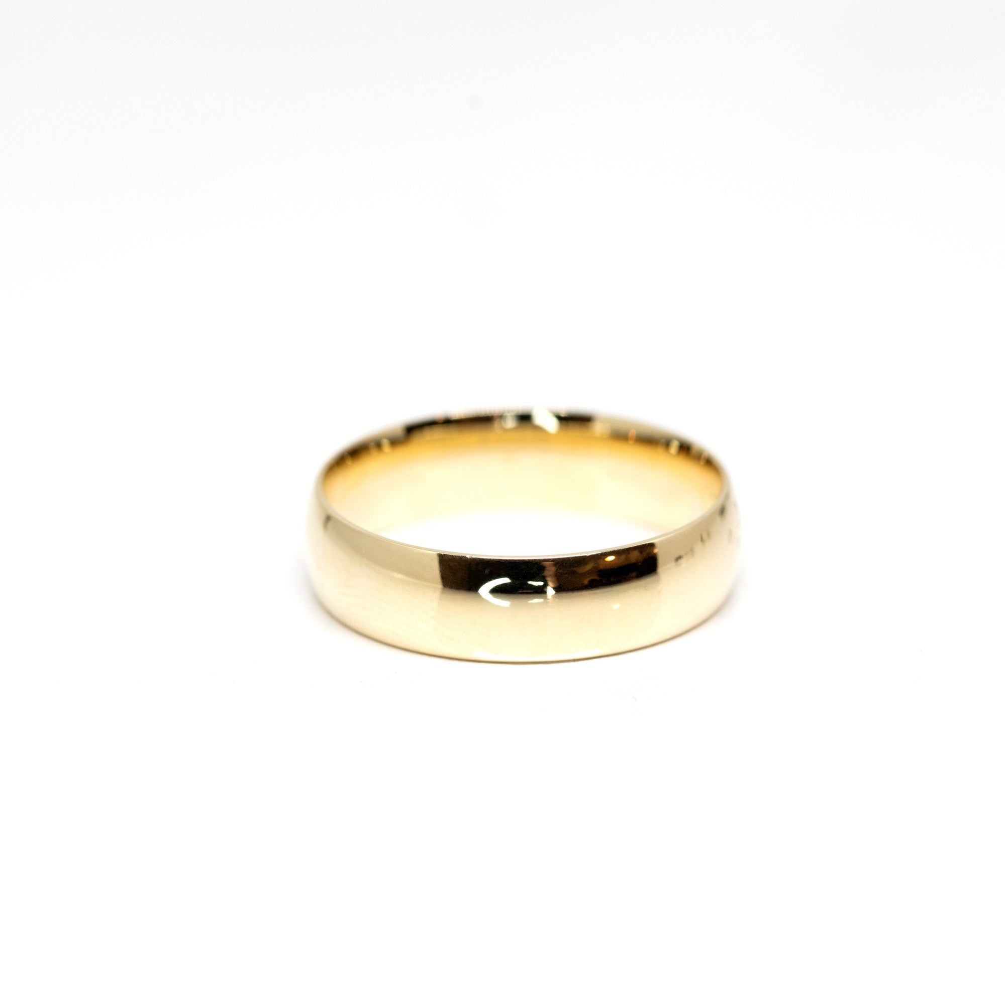 Classic domed wedding band in yellow gold, handcrafted in Montreal by Bena Jewelry, featuring a smooth curved profile for timeless elegance.