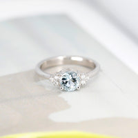 bena jewelry montreal cusotm made round aquamarine and diamond classic engagement ring on white background