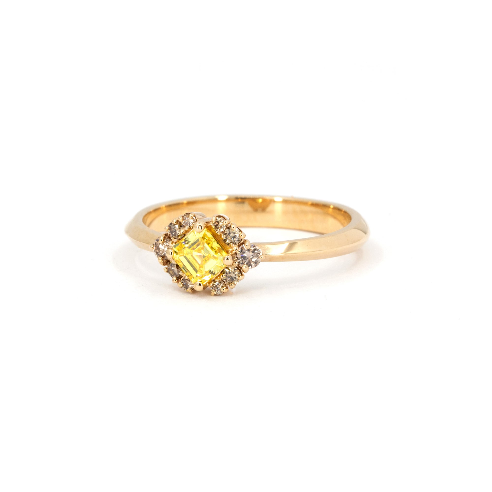 Top view of a handcrafted yellow and brown diamond ring by Bena Jewelry, fine jewelry made in Montreal, set in warm 14k gold, displayed on clean white surface.