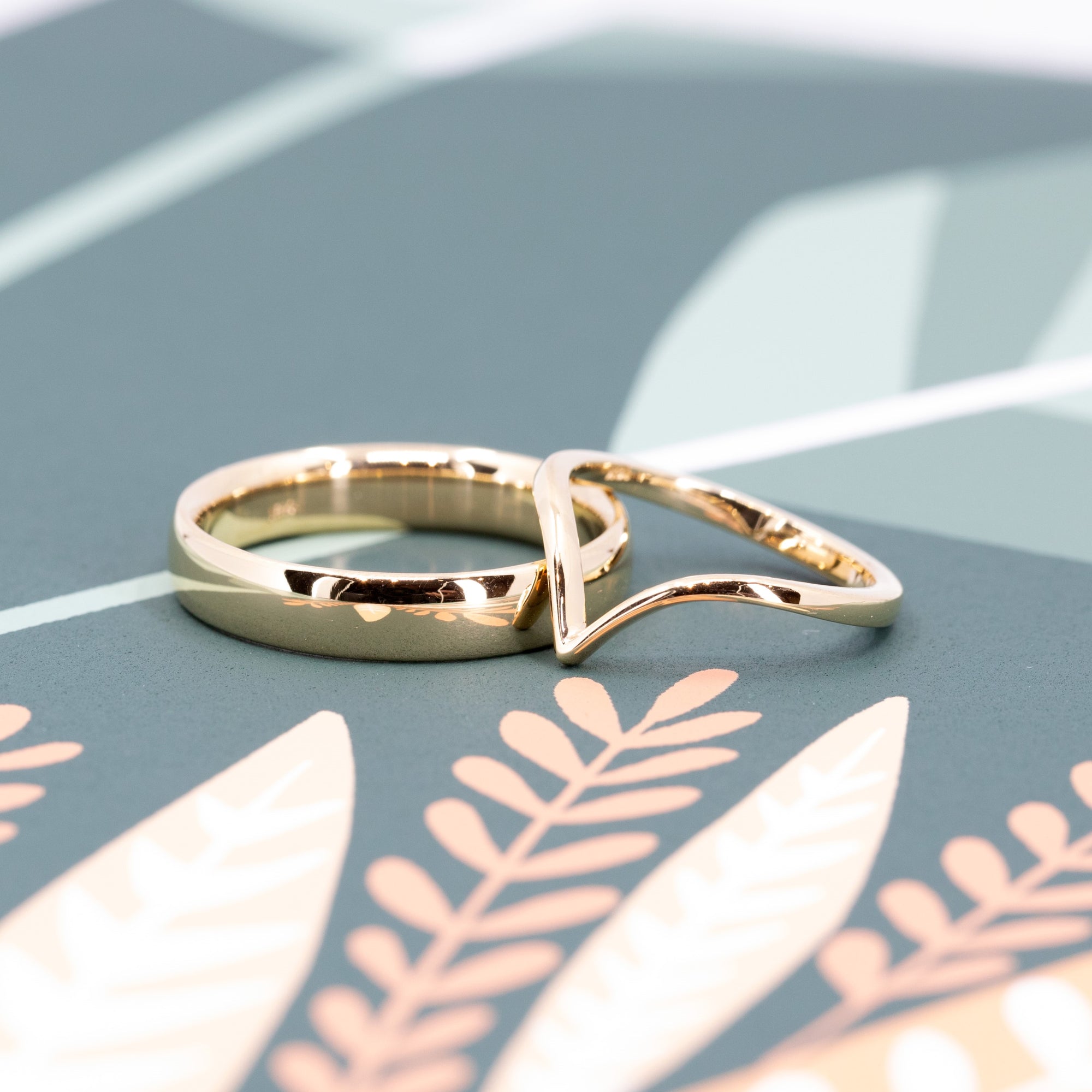 Close-up of the Custom V-Shaped Wedding Band and a men wedding band, made in Canada – A fine jewelry design with a subtle curve, crafted for a seamless bridal stack.