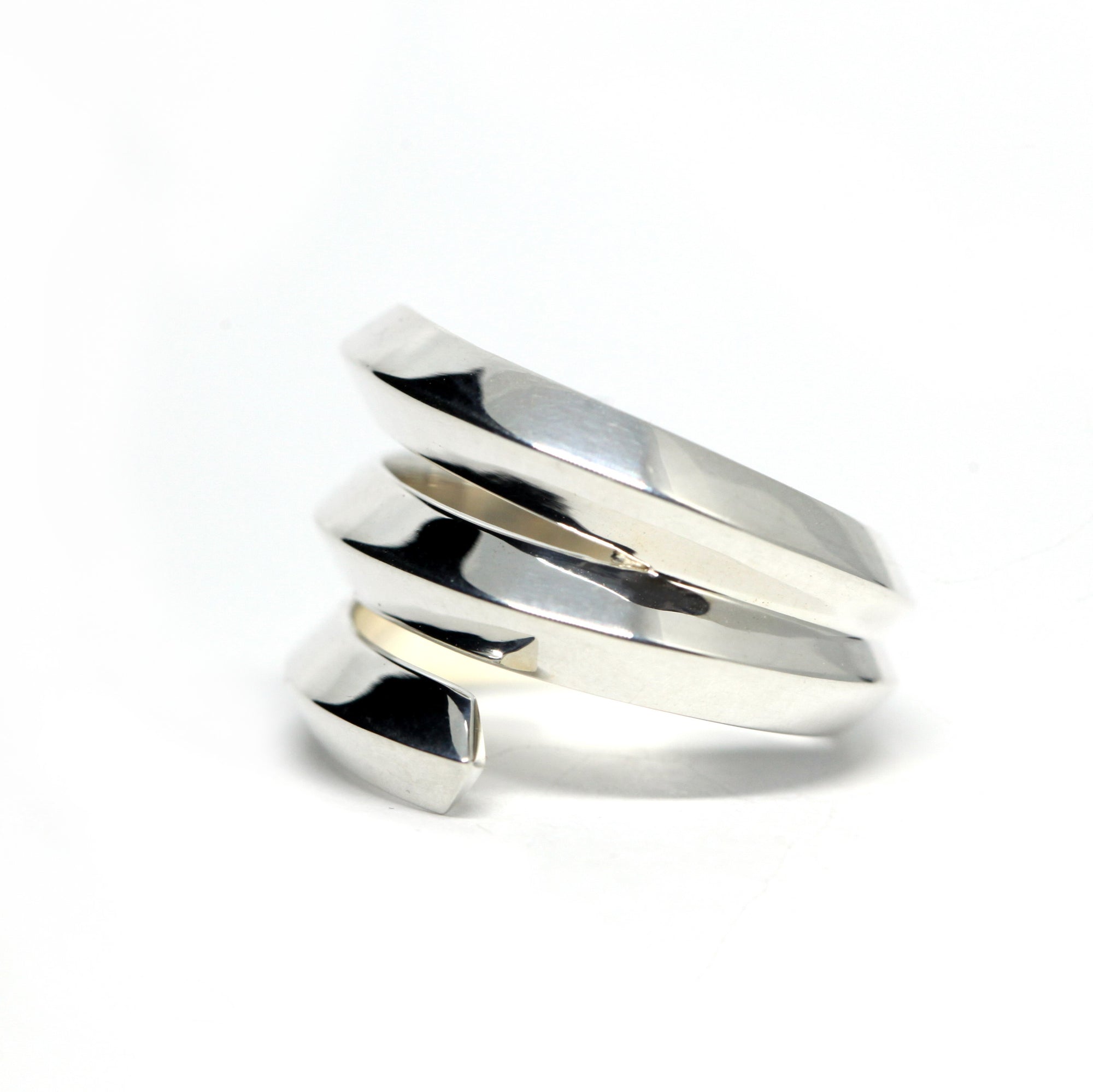 Close-up of Embrace Ring in White Gold – A unique statement ring with a strong geometric structure and high-polish finish.