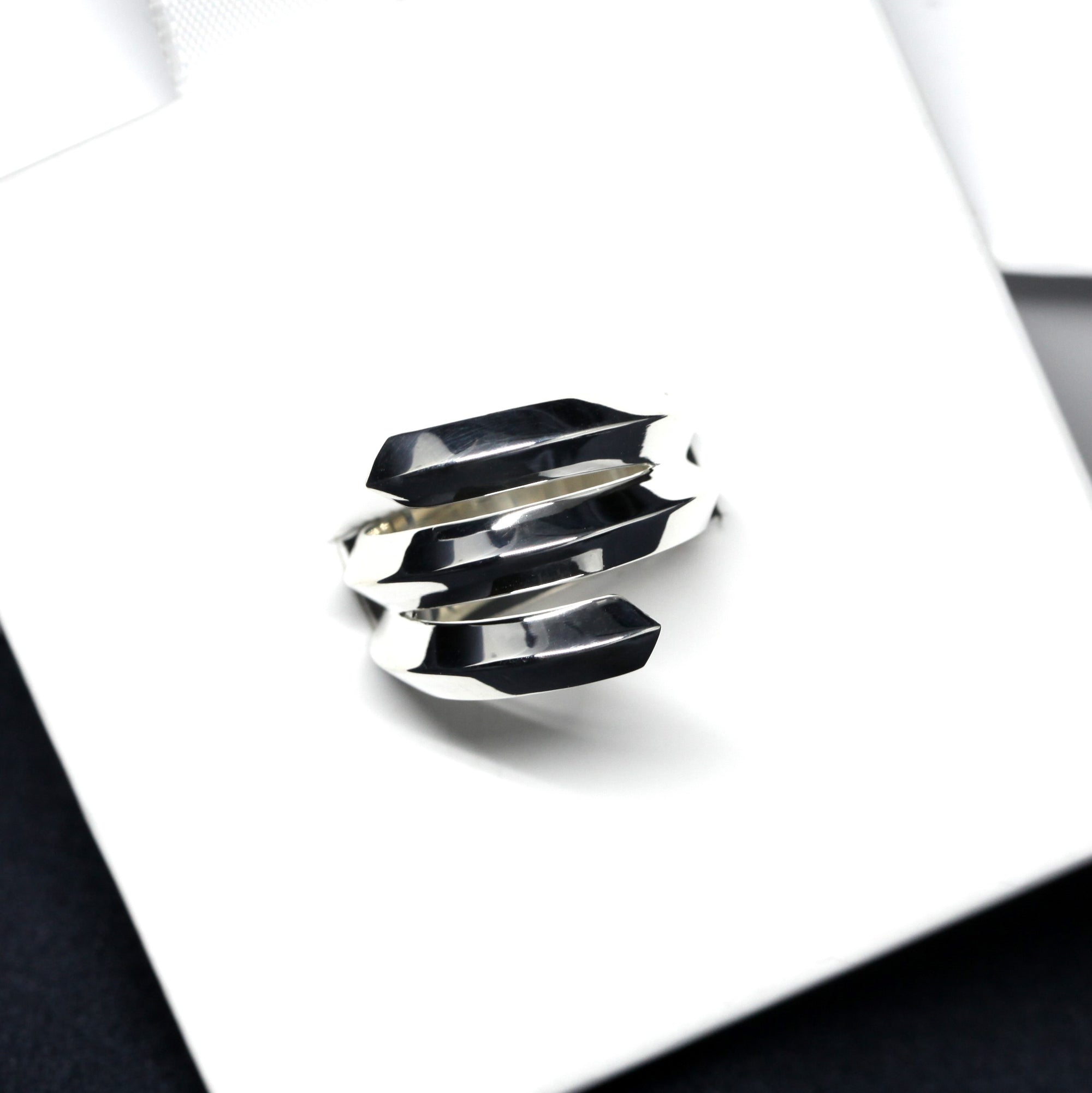 Embrace Ring in White Gold on white background – A bold and sculptural unisex ring with an edgy, layered design, handcrafted by Bena Jewelry in Montreal.