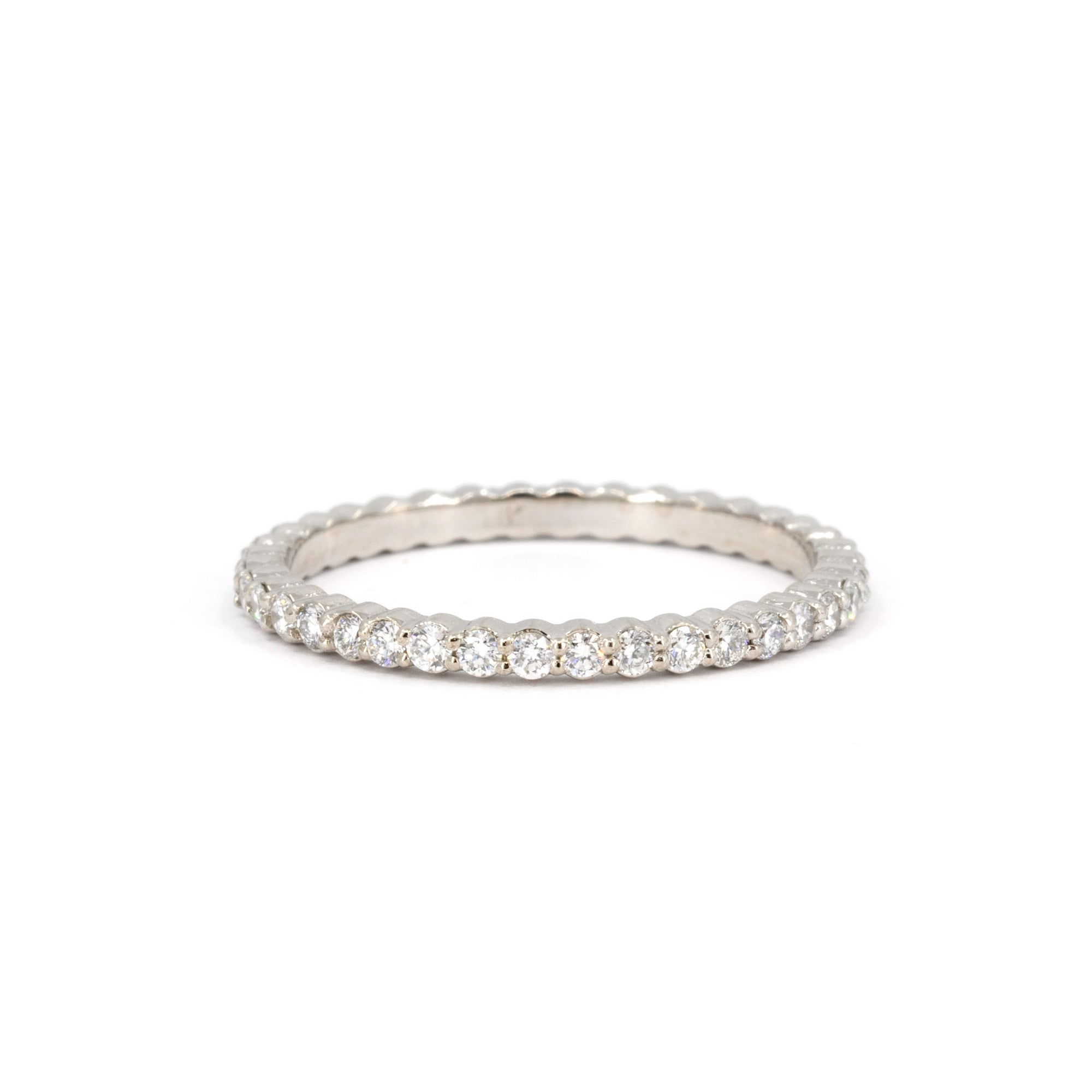 White gold eternity band with 1.50 mm round diamonds by Bena Jewelry. This sleek, custom-made ring is handcrafted in Montreal, showcasing its elegant design and timeless brilliance.