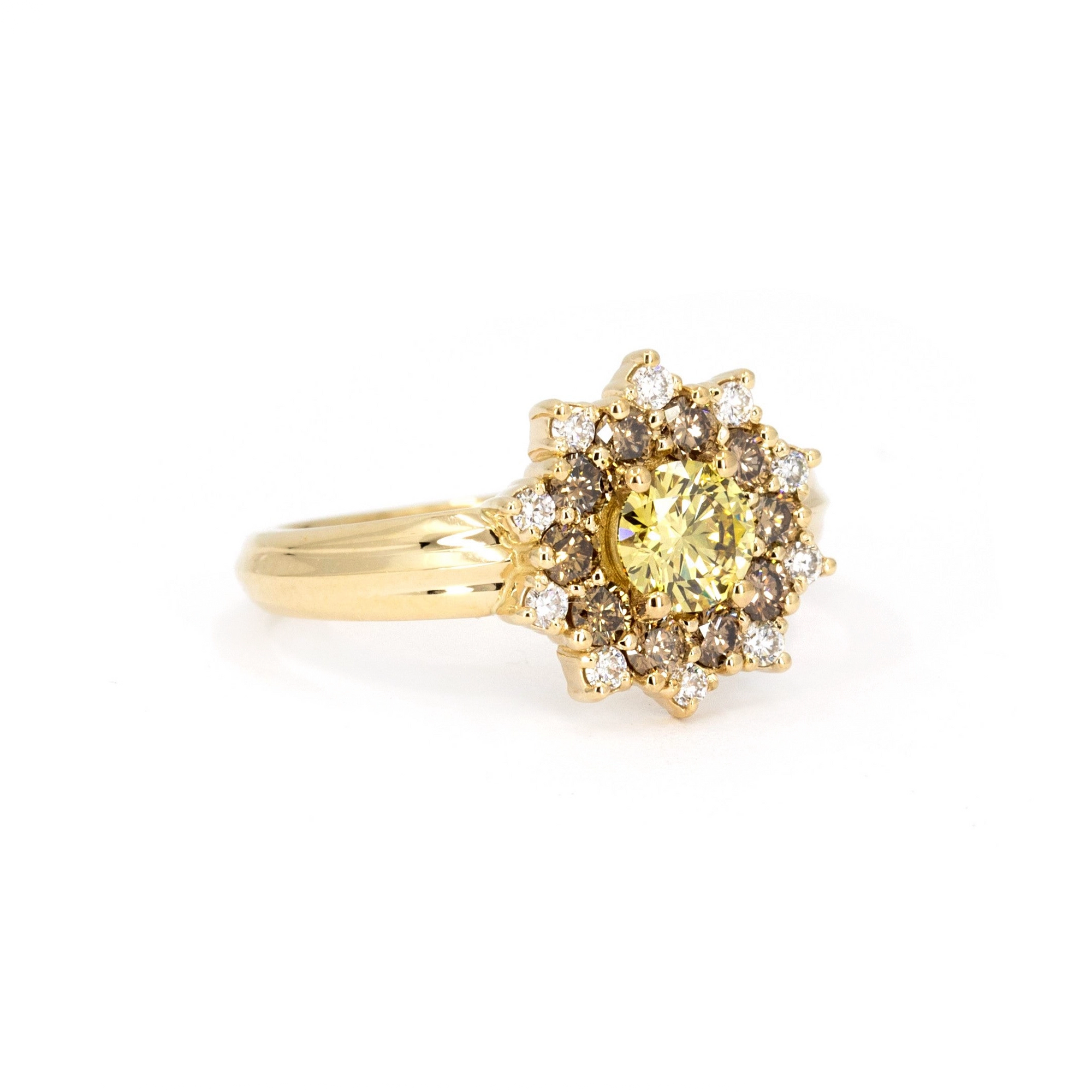 Close-up of the Soleil yellow diamond ring, featuring a central yellow diamond surrounded by brown and white diamonds, displayed against a white background by Bena Jewelry.