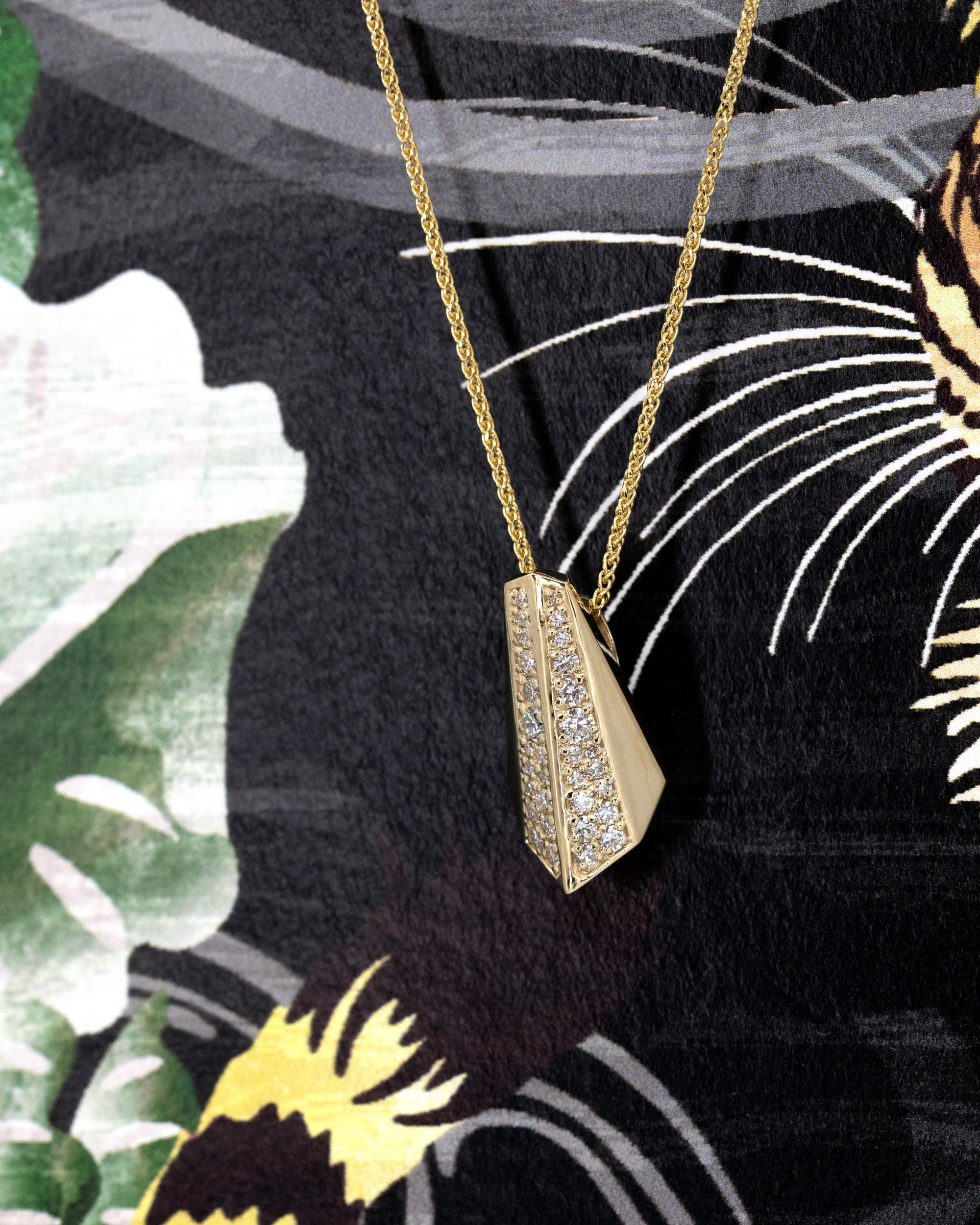 The Ballast pendant worn, showcasing its bold design and the striking contrast of yellow gold and diamond pavé. A powerful, unisex piece that exudes strength and sophistication.