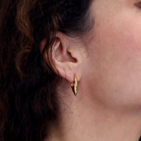 Girl wearing elegant gold plated silver earrings bena jewelry cast edgy jewelry collection montreal made in canada yellow gold plated silver earrings modern shape handmade in Montreal Made in Canada Fine Jewelry Designer