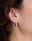 Women wearings sterling silver elegant silver earrings