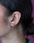 girl wearings two edgy gold stud made by bena jewelry montreal little itlay ruby mardi jeweler
