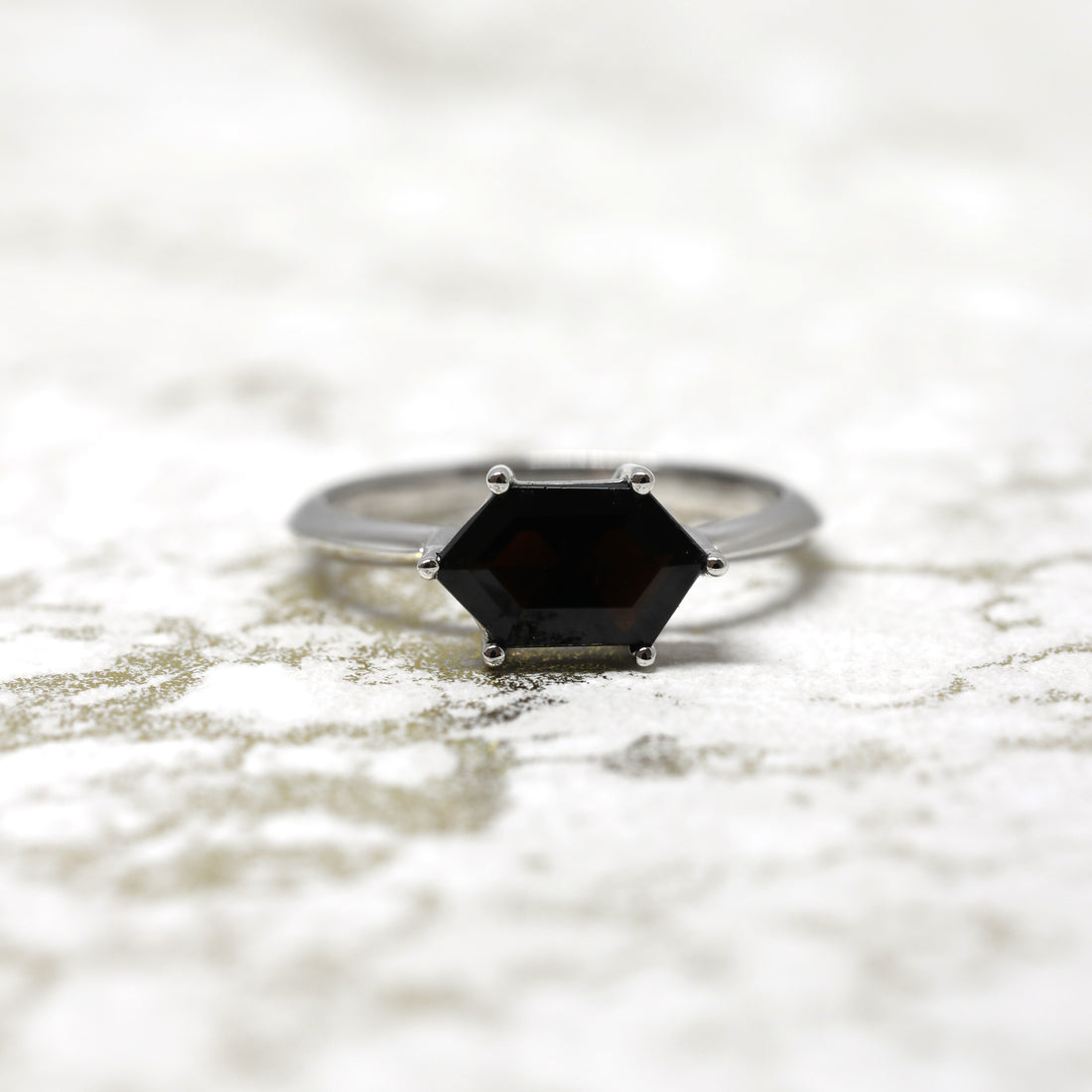 Front view of hexagonal black gemstone ring bridal edgy design bena jewelry montreal made in canada custom bridal jewelry color gemstone ring designer specialist montreal bold black dark gems bridal ring