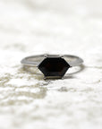 Front view of hexagonal black gemstone ring bridal edgy design bena jewelry montreal made in canada custom bridal jewelry color gemstone ring designer specialist montreal bold black dark gems bridal ring