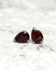 front view of pear shape garnet gemstone stud earrings red natural gemstone jewelry custom made bridal minimalist unisex fine jewelry montreal bena jewelry little italy montreal canada fine jeweler deep red garnet gemstone earrings